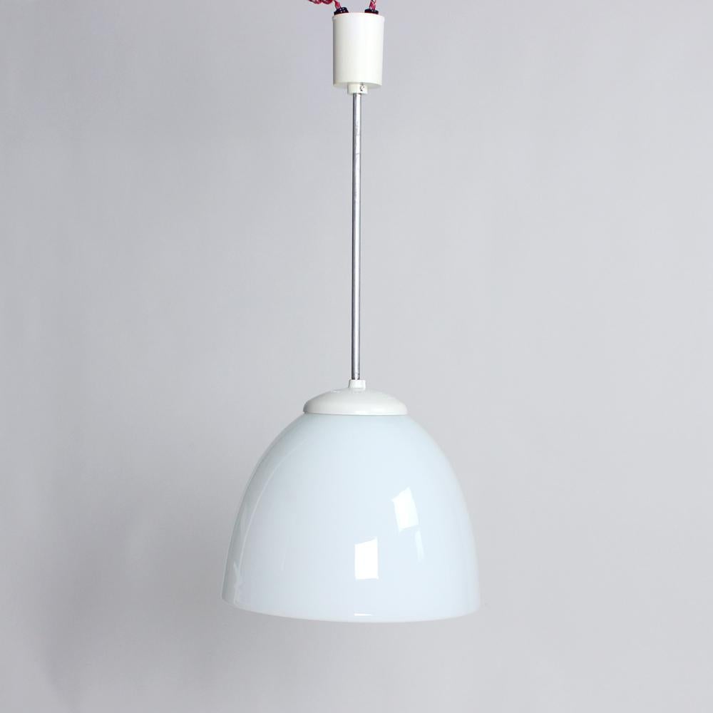 Elegant and tall ceiling light from Mid-Century Modern era. Produced in Czechoslovakia in 1960s. The light hangs on a slim metal stick construction. The shiel is made of pure white opaline glass in an interesting and elegant shape of a bell with