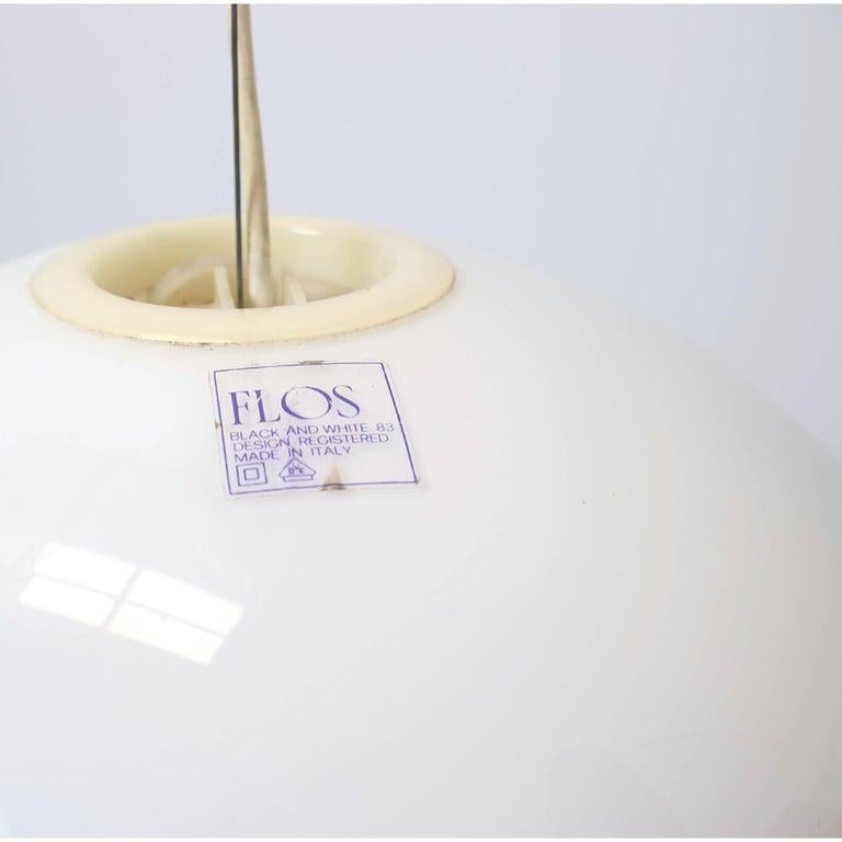 

First edition
Experience the ultimate in Italian design with this stunning white opaline glass pendant lamp by Achille and Pier Giacomo Castiglioni. Designed in 1965 and produced by Flos, this lamp is a true work of art that embodies the beauty