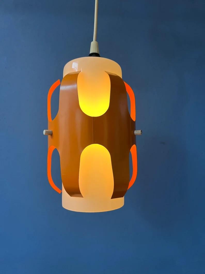 Small mid century opaline glass pendant lamp with orange iron frame. The orange frame produces a magnificent light effect together with the glass shade. The lamp requires one E27/26 lightbulb.

Additional information:
Materials: Metal
Period: