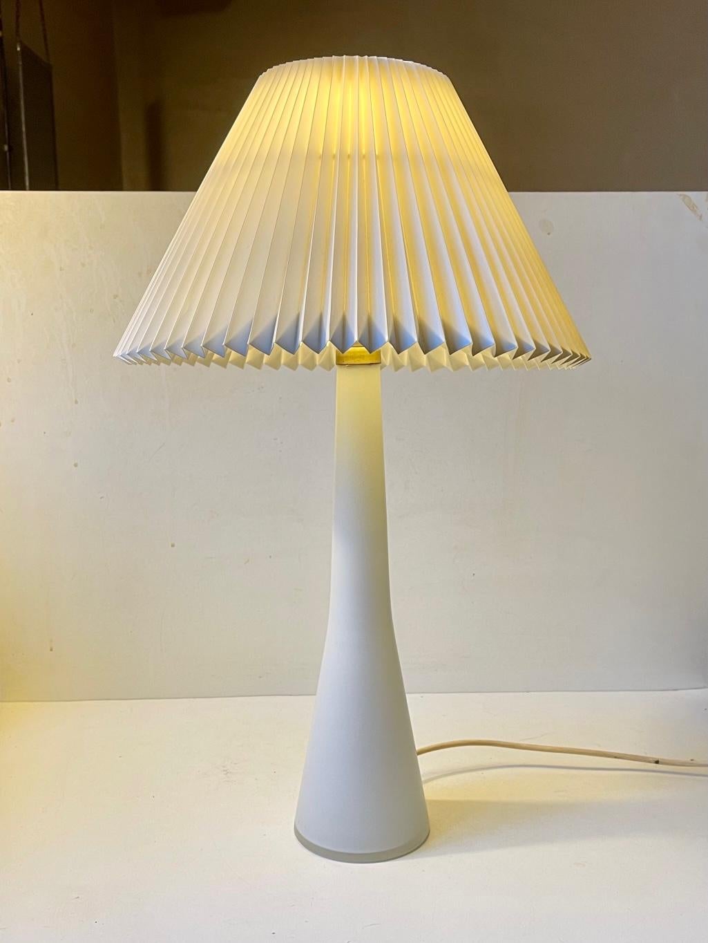 Large and exceptionally rare table light in frosted matté opaline glass. Manufactured by Voss/Holmegaard for Le Klint in Denmark during the 1950s or early 1960s. The fluted vintage Le Klint Shade by Tage Klint is made from folded paper and is