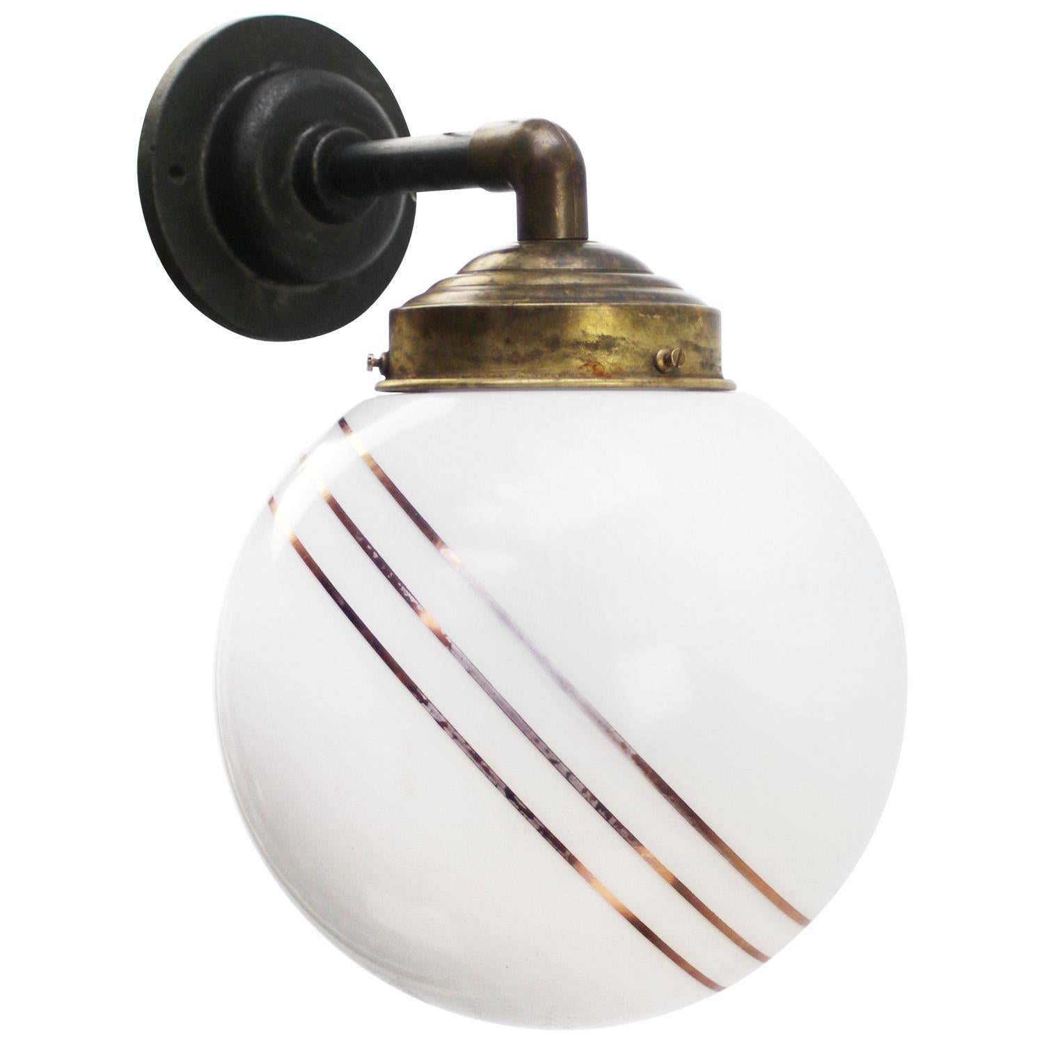 Brass and cast Iron Industrial wall light
White opaline glass globe with 3 golden stripes

Diameter cast iron wall piece: 10.5 cm / 4”, 2 holes to secure

Weight: 2.50 kg / 5.5 lb

Priced per individual item. All lamps have been made suitable by