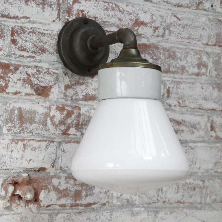 Porcelain industrial wall lamp.
White porcelain, brass and cast iron
White opaline milk glass.
2 conductors, no ground.

Diameter cast iron wall piece 10 cm. 2 holes to secure.

Weight: 2.05 kg / 4.5 lb

Priced per individual item. All