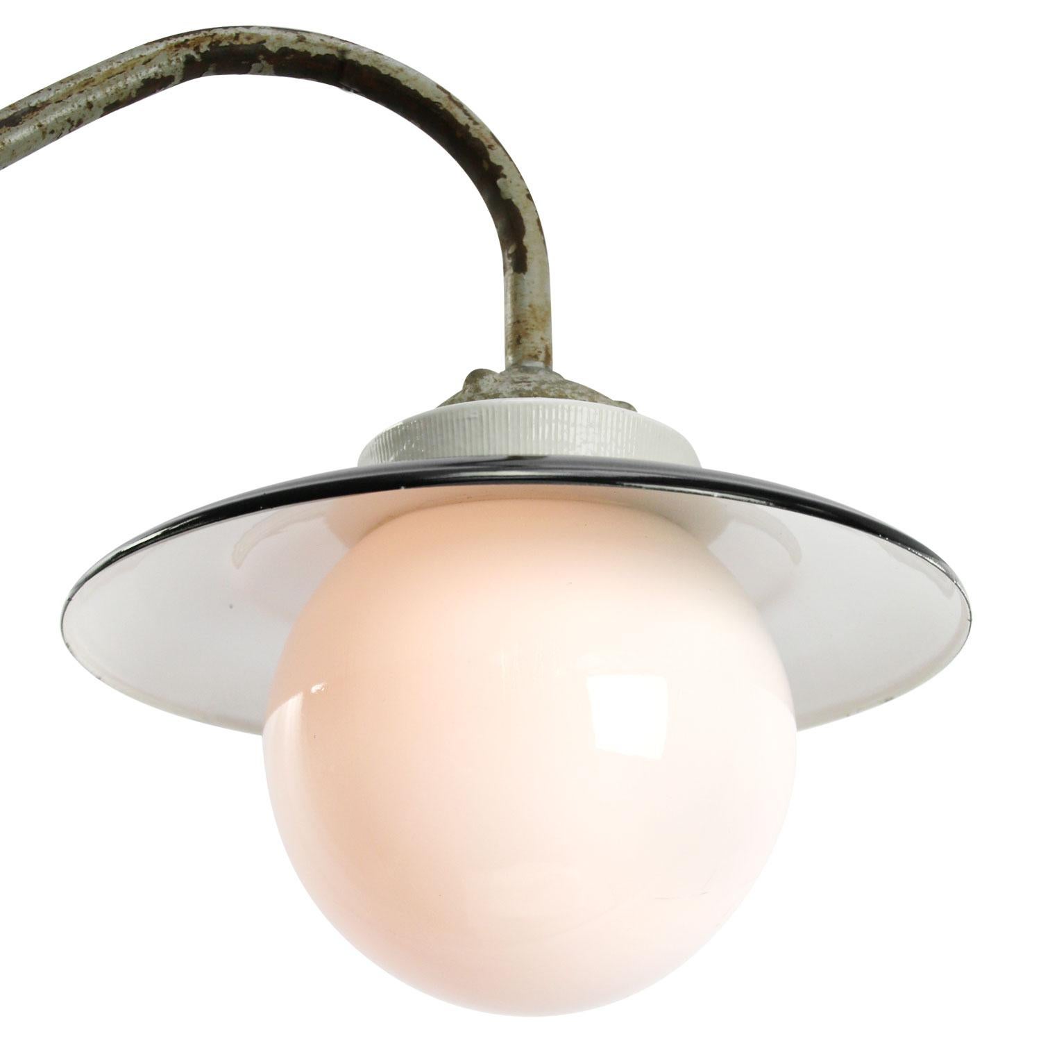 Black enamel industrial wall light with white interior.
Cast iron and porcelain top, opaline glass.
Diameter cast iron wall mount: 9 cm, 3 holes to secure.

Weight: 2.10 kg / 4.6 lb

Priced per individual item. All lamps have been made