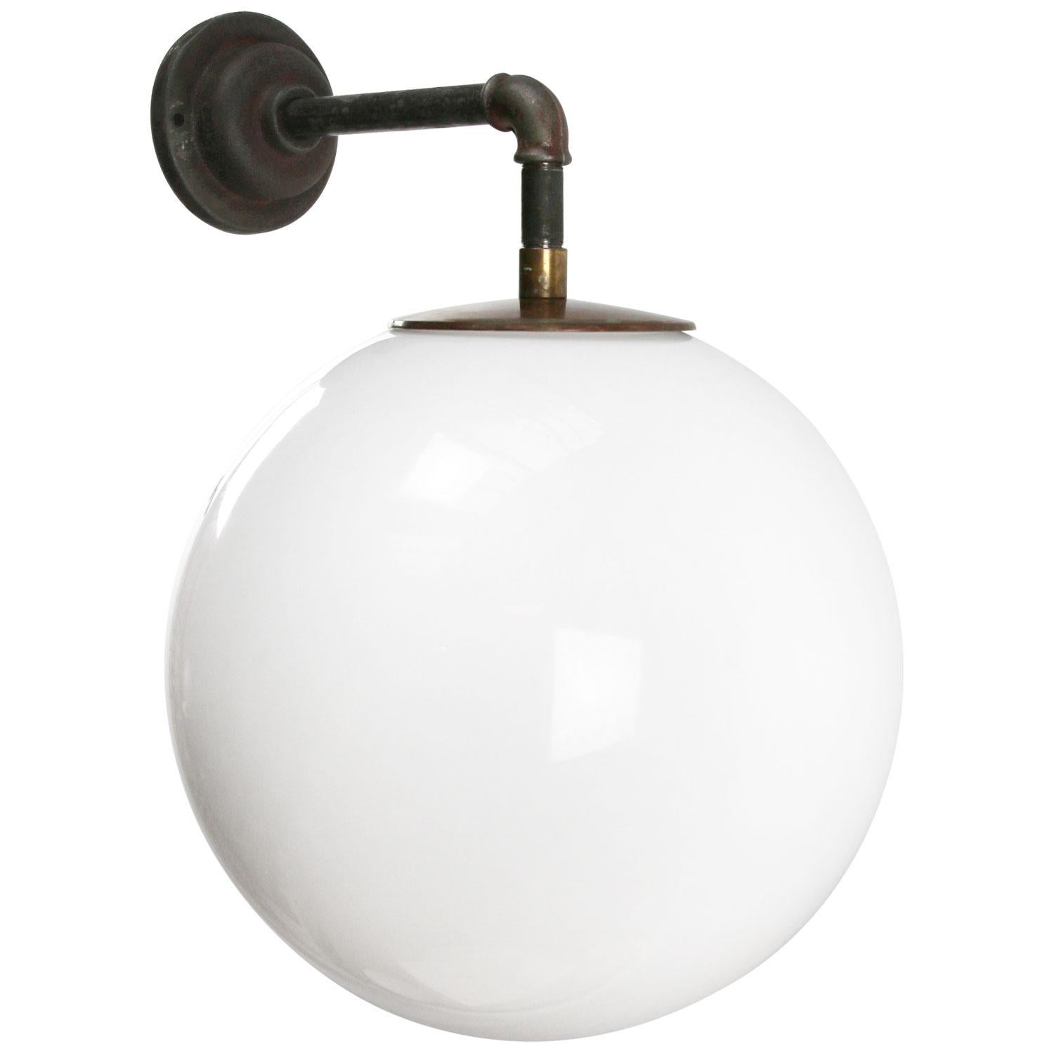 Opaline glass industrial wall light.
Brass top.

Measures: Diameter cast iron wall piece 10.5 cm / 4”, 2 holes to secure

Weight: 5.30 kg / 11.7 lb

Priced per individual item. All lamps have been made suitable by international standards for