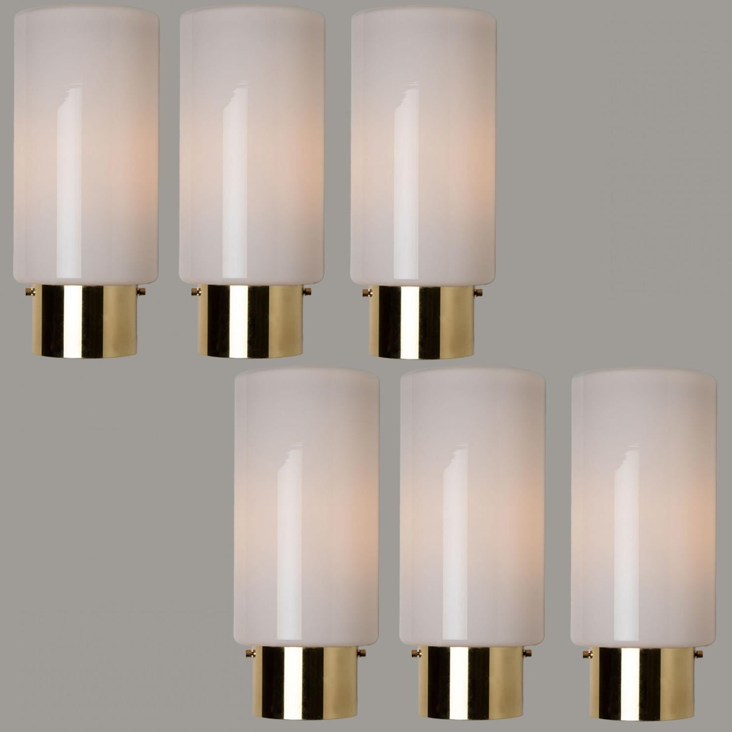 Heavy quality glass lamps with brass base. Beautiful white, opaque glass. Manufactured by the company Glasshütte Limburg, in Germany, Europe around 1970. This wall lights give a warm light that suits any space.

Please notice the price is for 1
