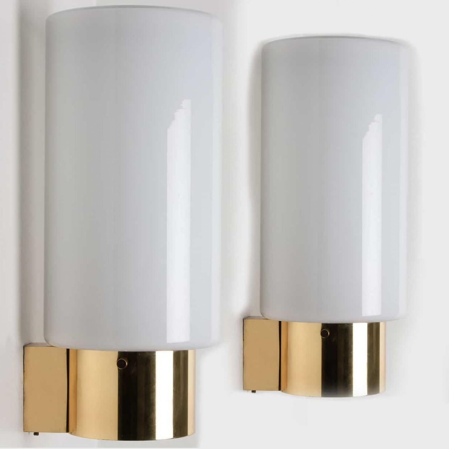 Heavy quality glass lamps with brass base. Beautiful white, opaque glass. Manufactured by the company Glasshütte Limburg, in Germany, Europe around 1970. This wall lights give a warm light that suits any space.

Please notice the price is for 1