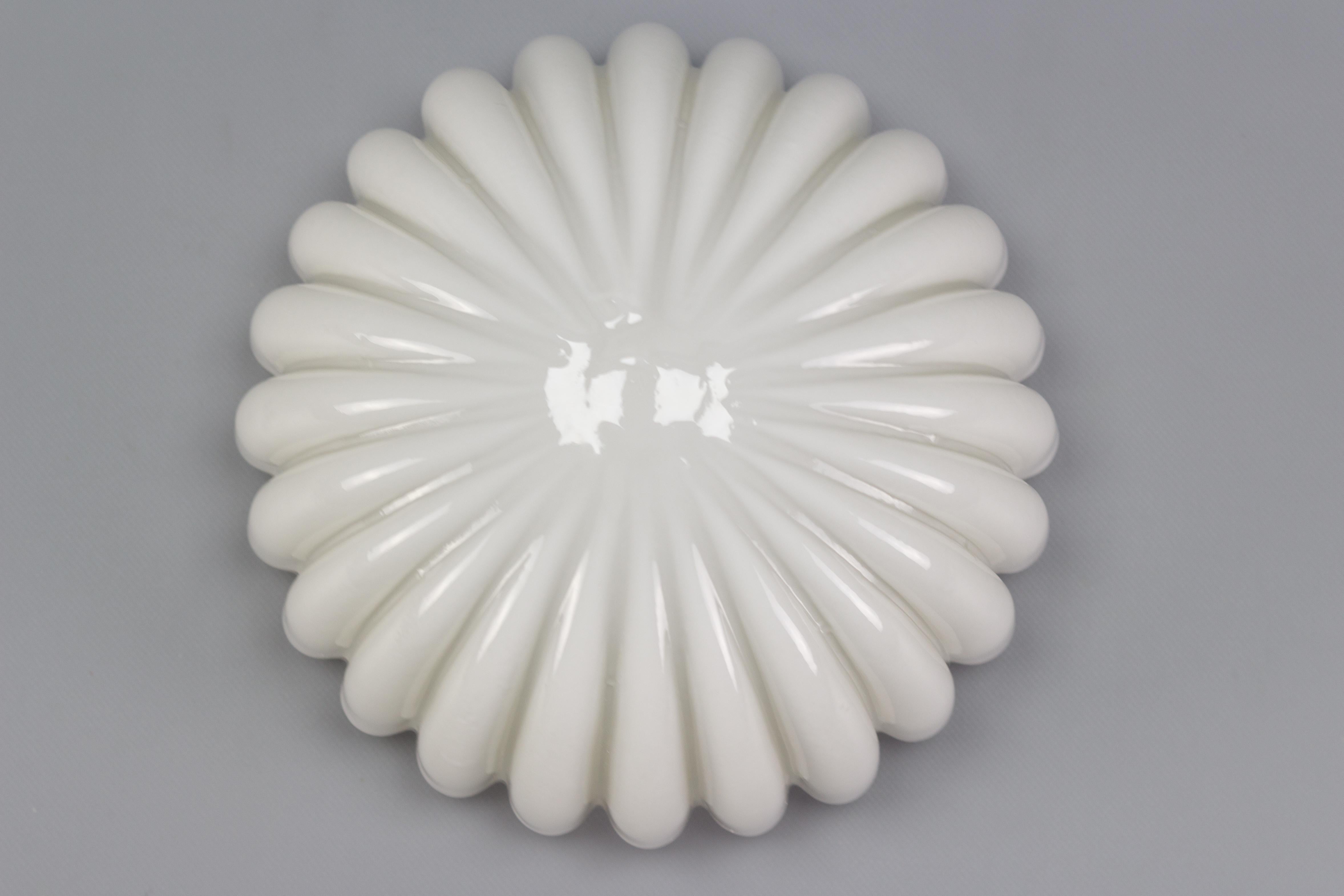 An adorable flower-shaped white opaque glass flush mount or wall light by Doria Leuchten, the 1960s, Germany.
One socket for a light bulb of size E27 (E26).
Dimensions: height: 15 cm / 5.9 in; diameter: 26 cm / 10.23 in.
  