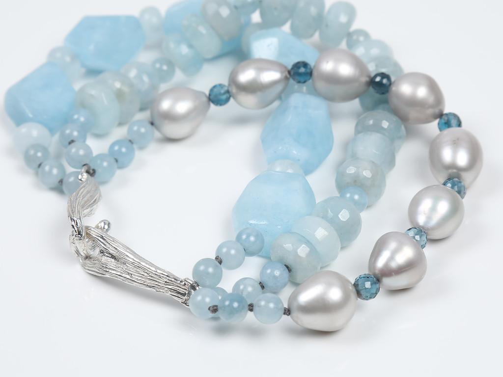 A three-strand bracelet of three shapes of soft, blue; faceted London blue topaz; silver baroque freshwater pearls; and an artisan-created White Orchid Studio vanilla bean clasp in 925 sterling. 8.5