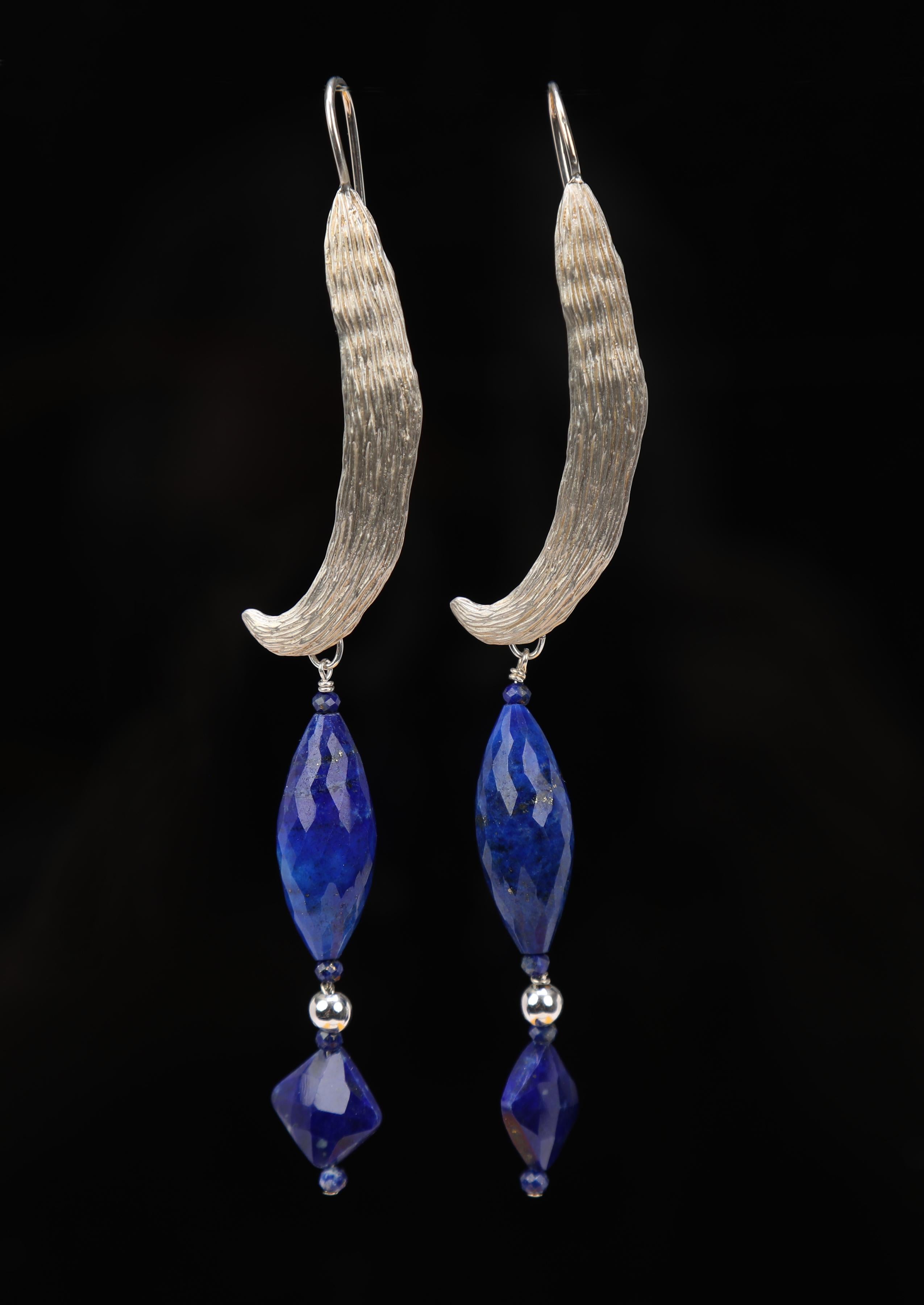 This lapis lazuli and silver ear wire spotlights a custom ear wire White Orchid Studio created for 