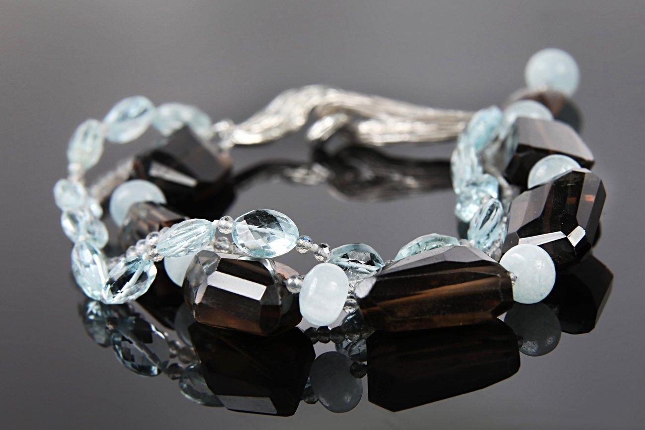 PRODUCT DETAILS
This smoky quartz, aquamarine, hypersthene, and silver bracelet offers endless ways to express your individuality.  