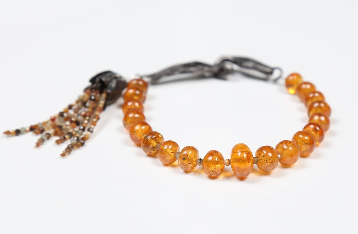 This mandarin garnet, orange sapphire, and silver bracelet exudes optimism and creativity.  