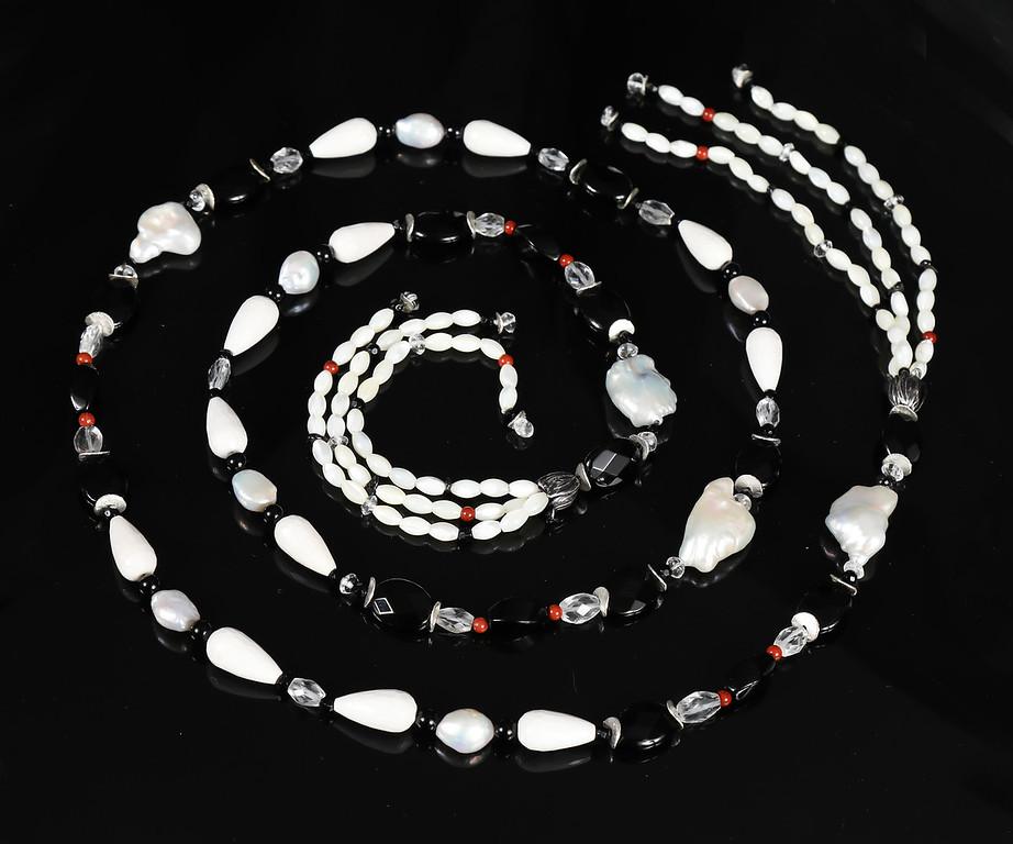 This pearl, onyx, agate, quartz, jasper, and silver necklace-a  sautoir in French-continues a cherished tradition.  Centuries ago sautoirs incorporated royal insignia into pageantry.  Pearls were especially honored.  Coco Chanel modernized the look,