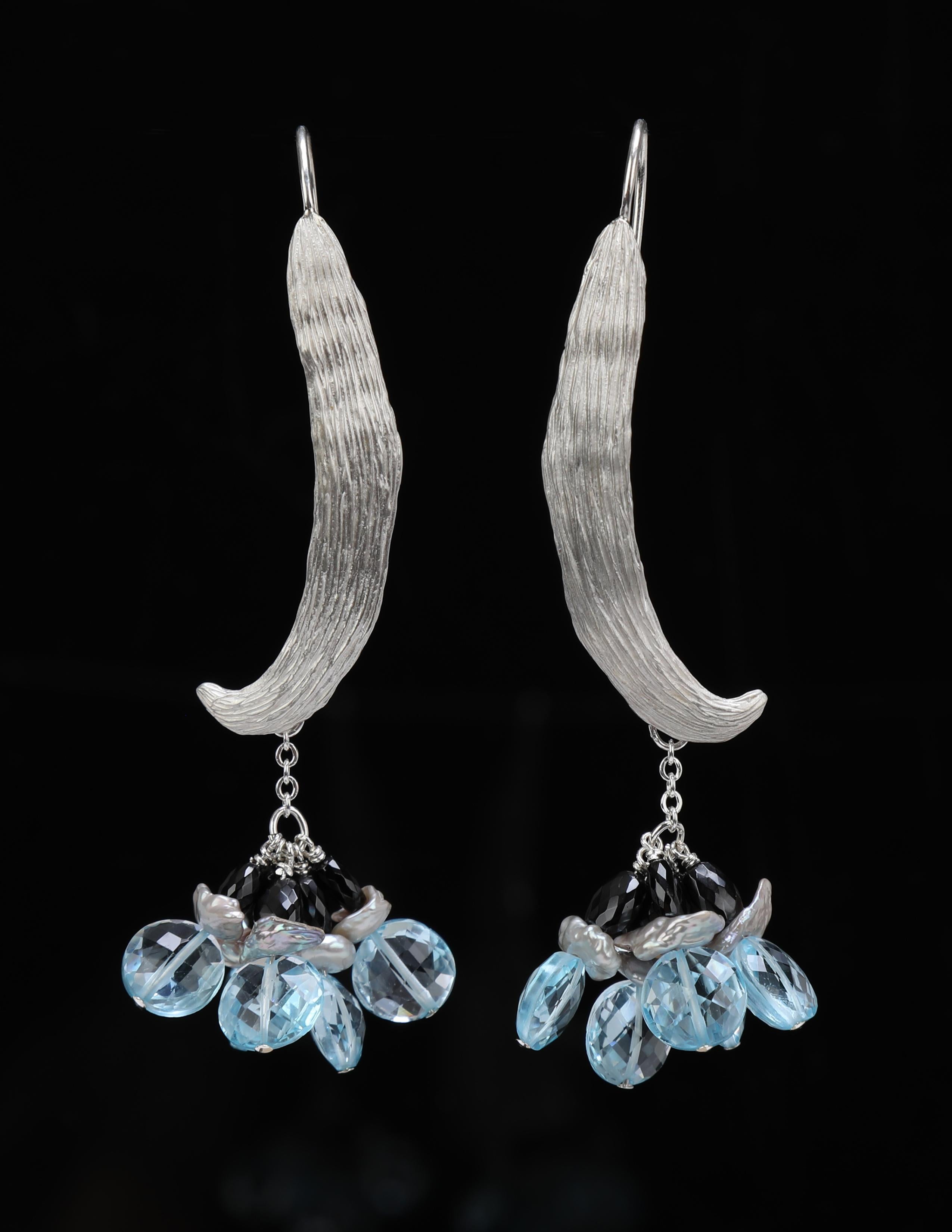 This sky blue topaz, pearl, black spinel, and silver dangle ear wire spotlights White Orchid Studio's custom, vanilla bean ear wire created for 