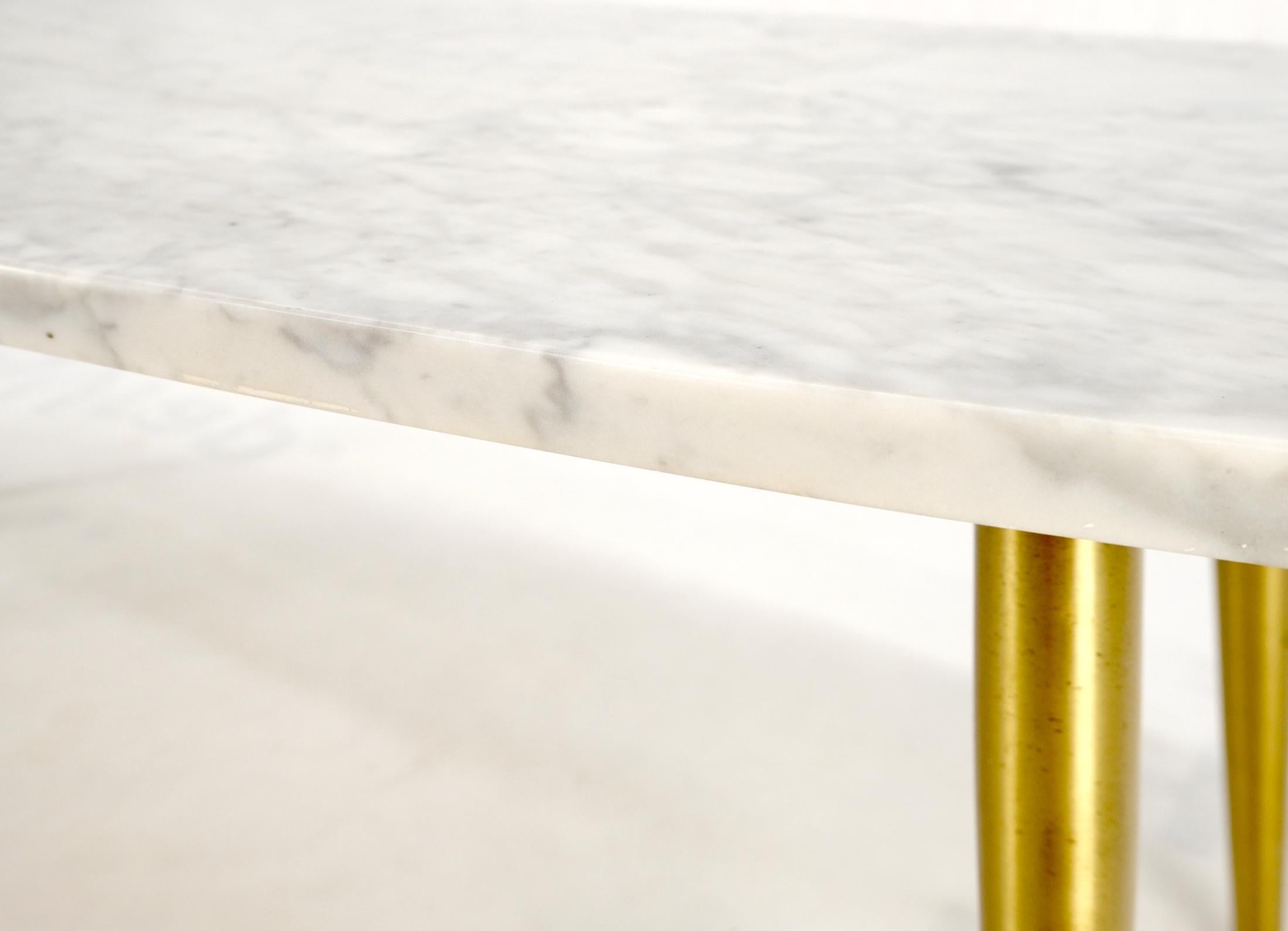 White oval Carrara marble top Italian Mid-Century Modern coffee table tapered brass legs.