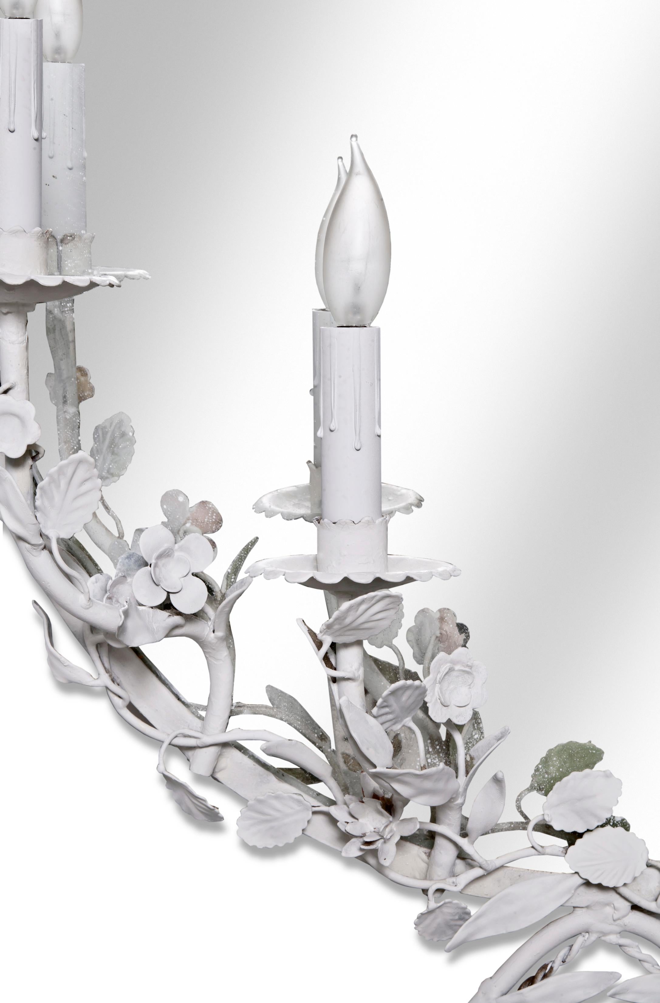 Italian Oval mirrored sconce with 4 lights. Refreshed in hand painted white finish.
Iron flowers & leaves. Newly rewired with clear cord & in line switch. Takes standard chandelier 5-15 W bulbs.