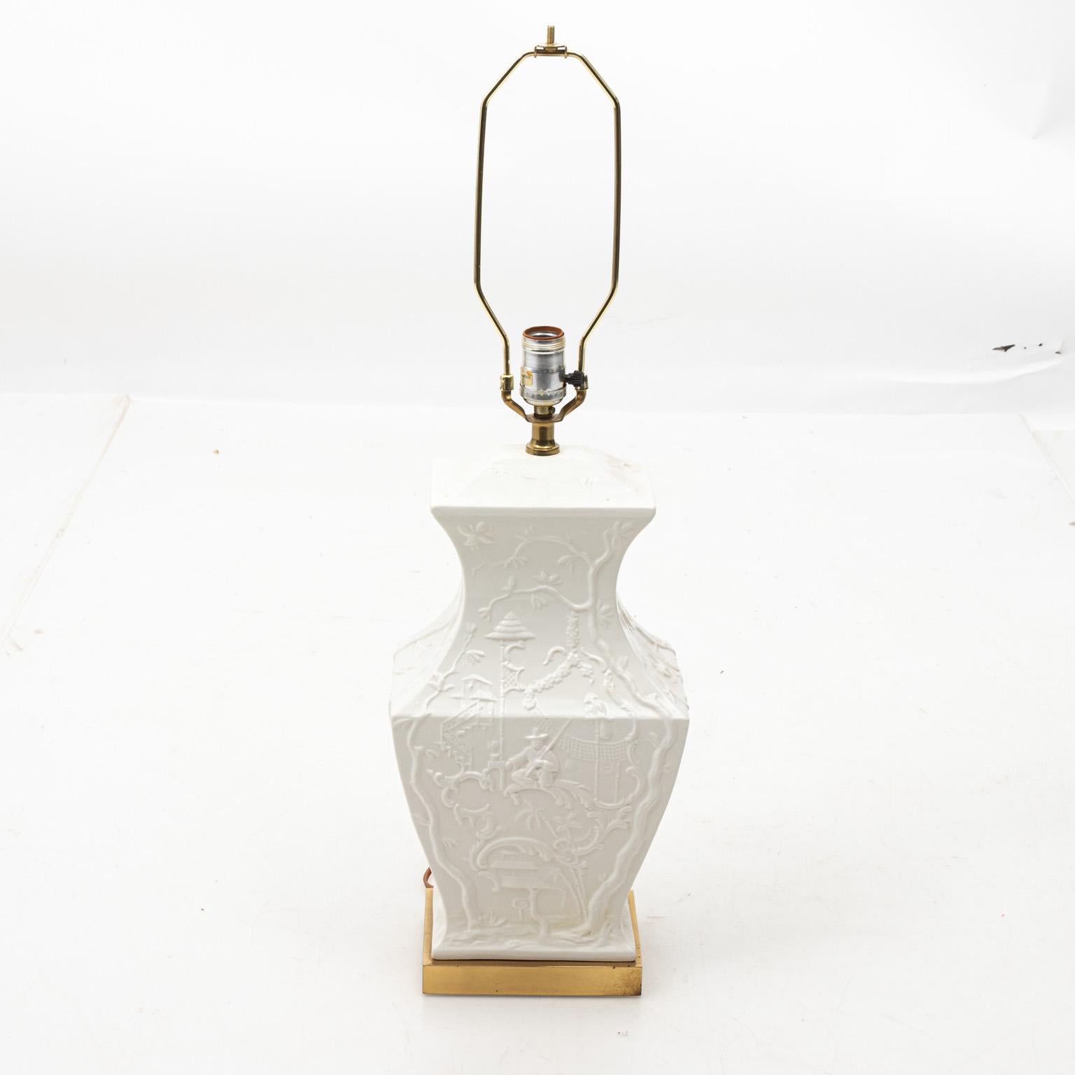 White painted chinoiserie ceramic lamp with brass base, circa 1970s. Please note of wear consistent with age including slight markings on the base. Shades not included.