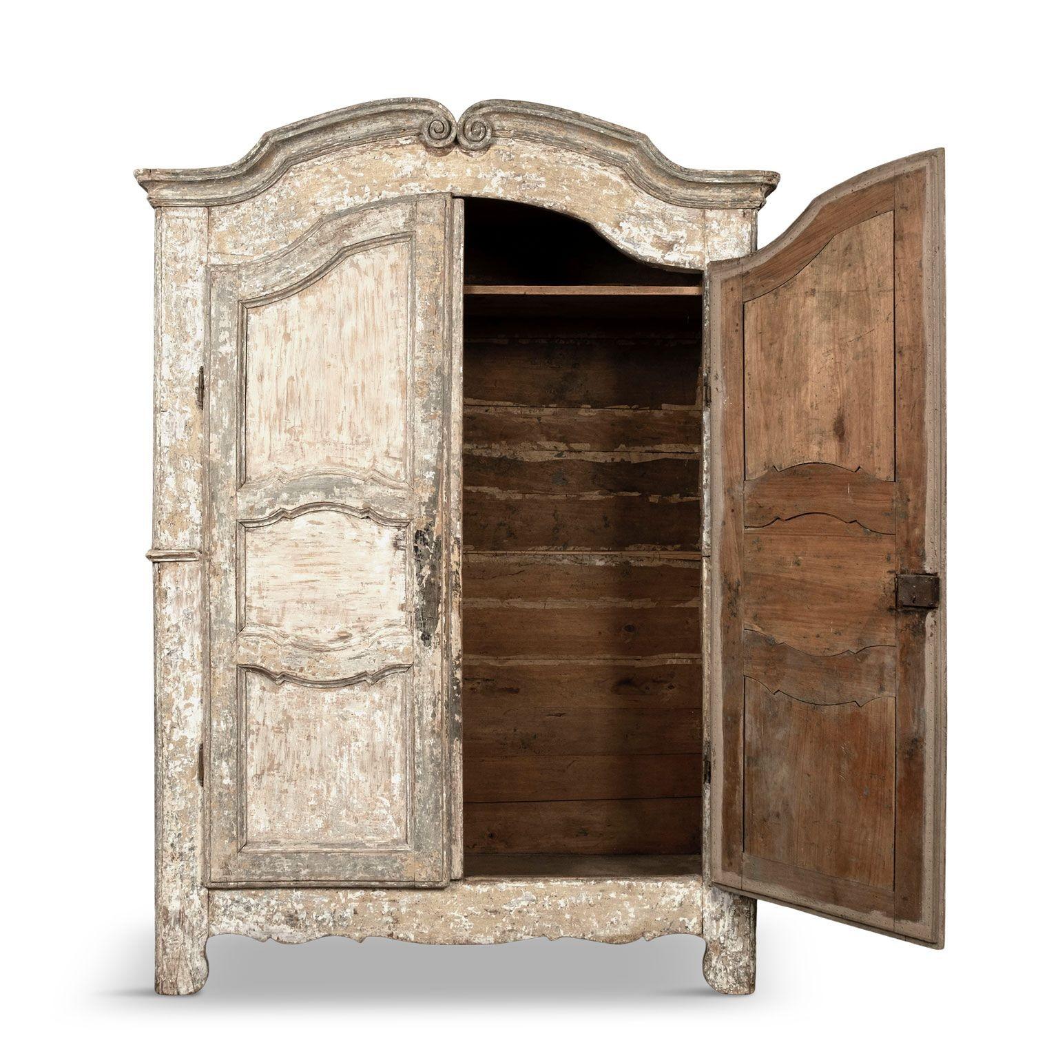 White painted French rococo wardrobe dating to circa 1740-1769. Mostly likely from Northern France. Excellent hand-carved details. Scraped back painted finish in revealed layers of white, cream and light gray colors.