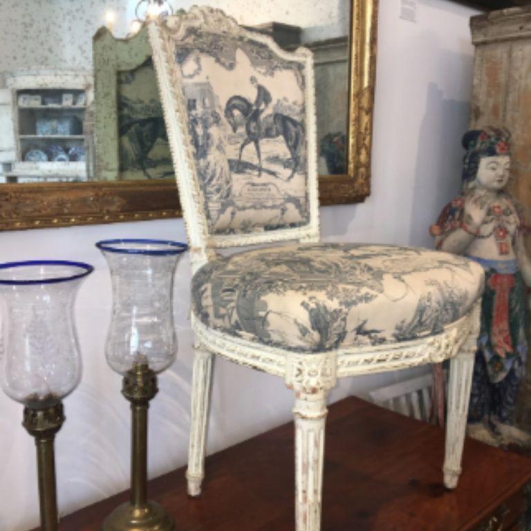 Charming Louis XVI style, French 19th century painted and carved chair with muted navy and cream equestrian toile de jouy featuring the famous 1865 triple-crown winner Gladiateur.