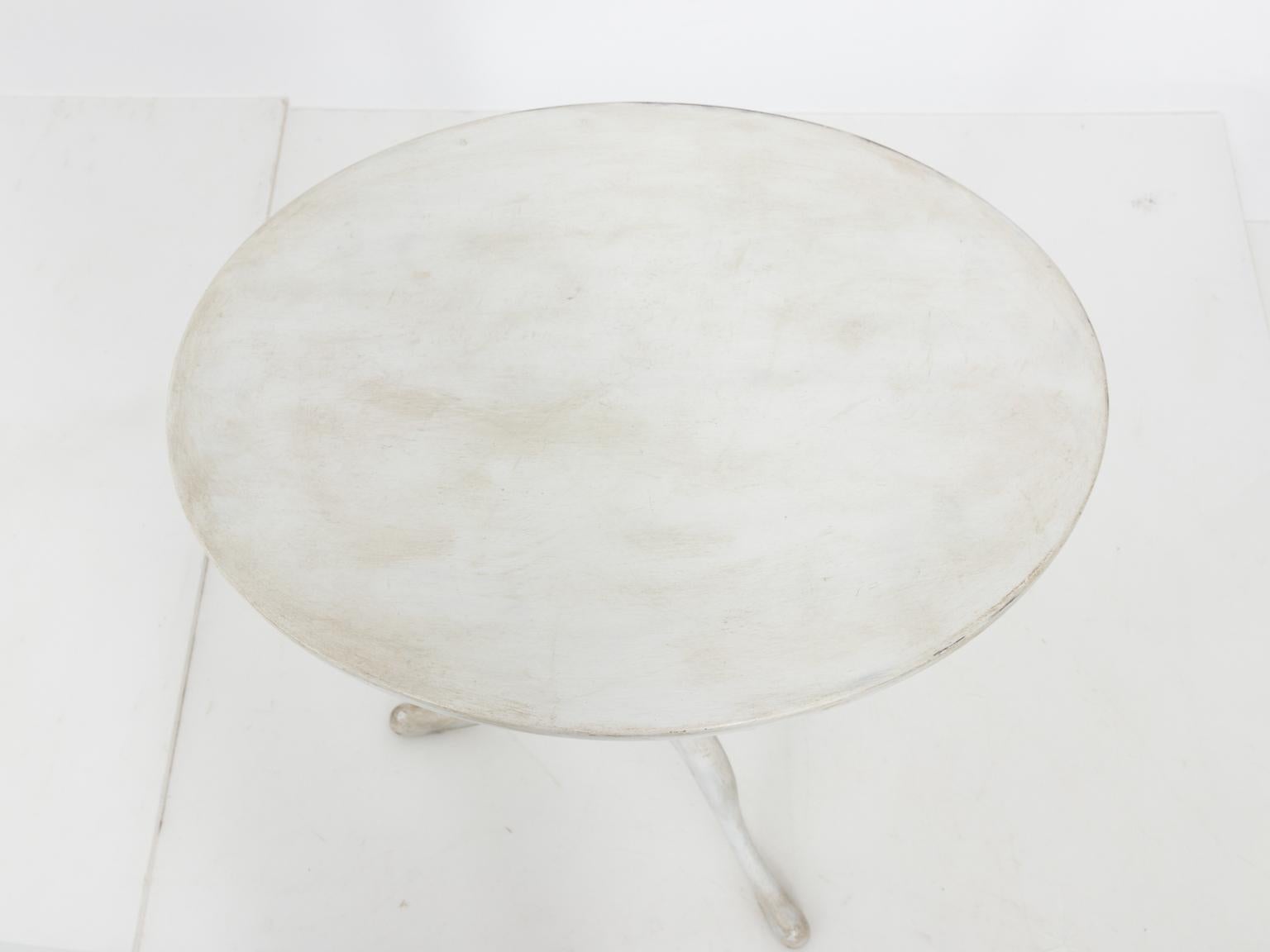 Gustavian style white painted oval tilt-top table with tripod base and turned column, circa 1930s. Original patina is featured.
   