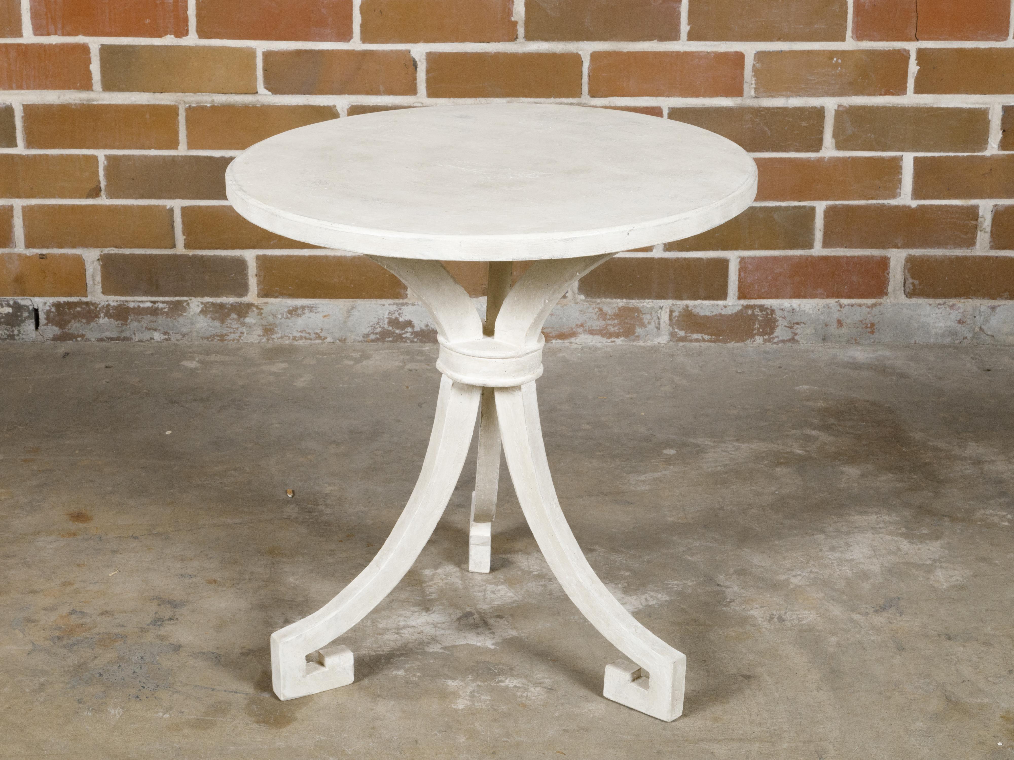 An Italian wooden side table with white painted finish, round top and tripod base. This Italian wooden side table exudes a blend of elegance and simplicity, perfect for adding a touch of timeless style to any interior. The table features a white