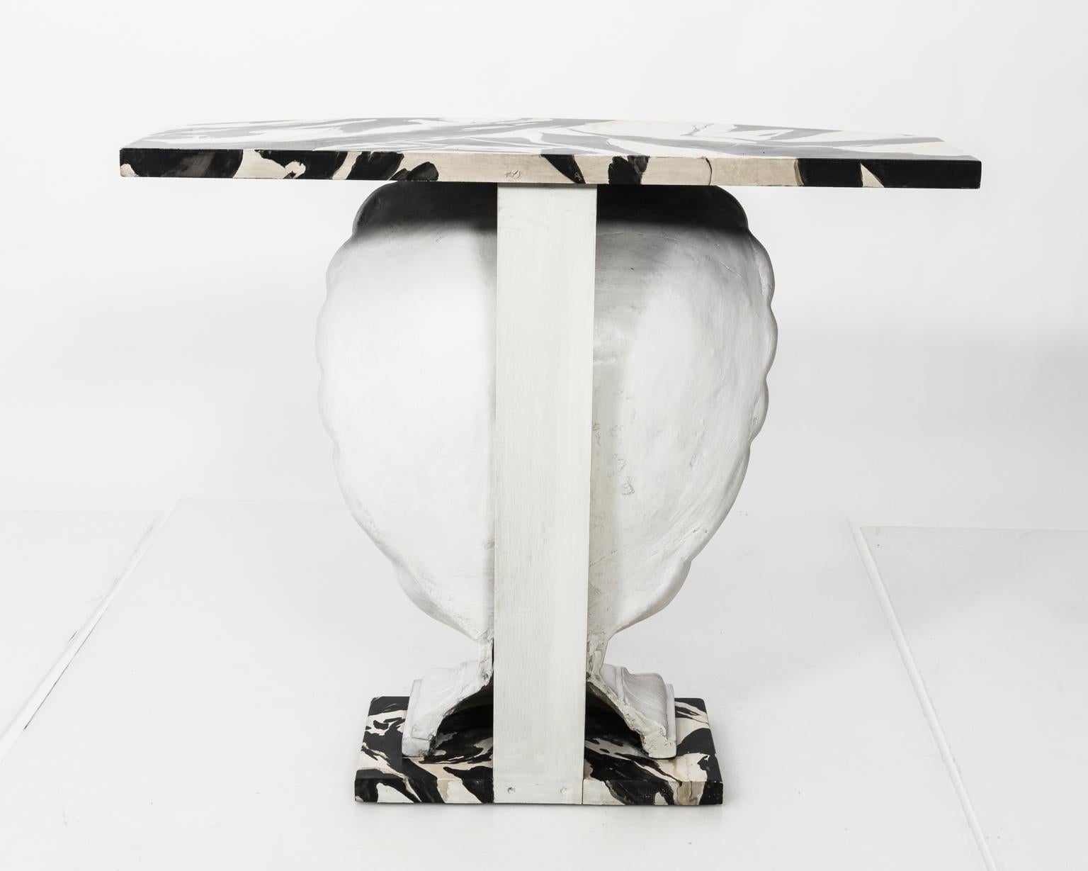 Contemporary white painted plaster scallop shell console with hand painted faux marble top on a plinth base.
