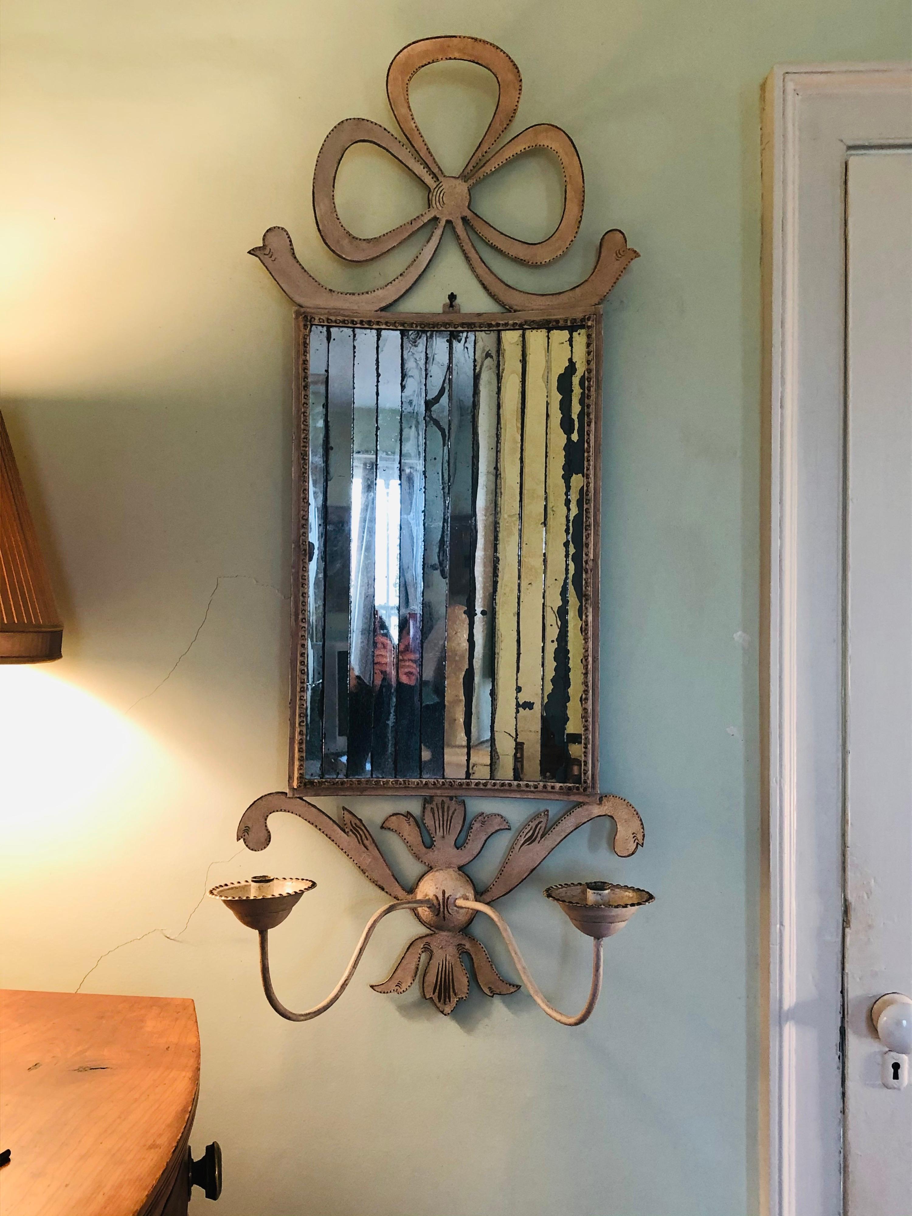 Stylish white painted tole and mirrored two-light sconce or candleholder. White paint with gold paint details. Probably English. A little loss to the mirror but gives a nice overall patina to the glass. Really a handsome piece for any wall.