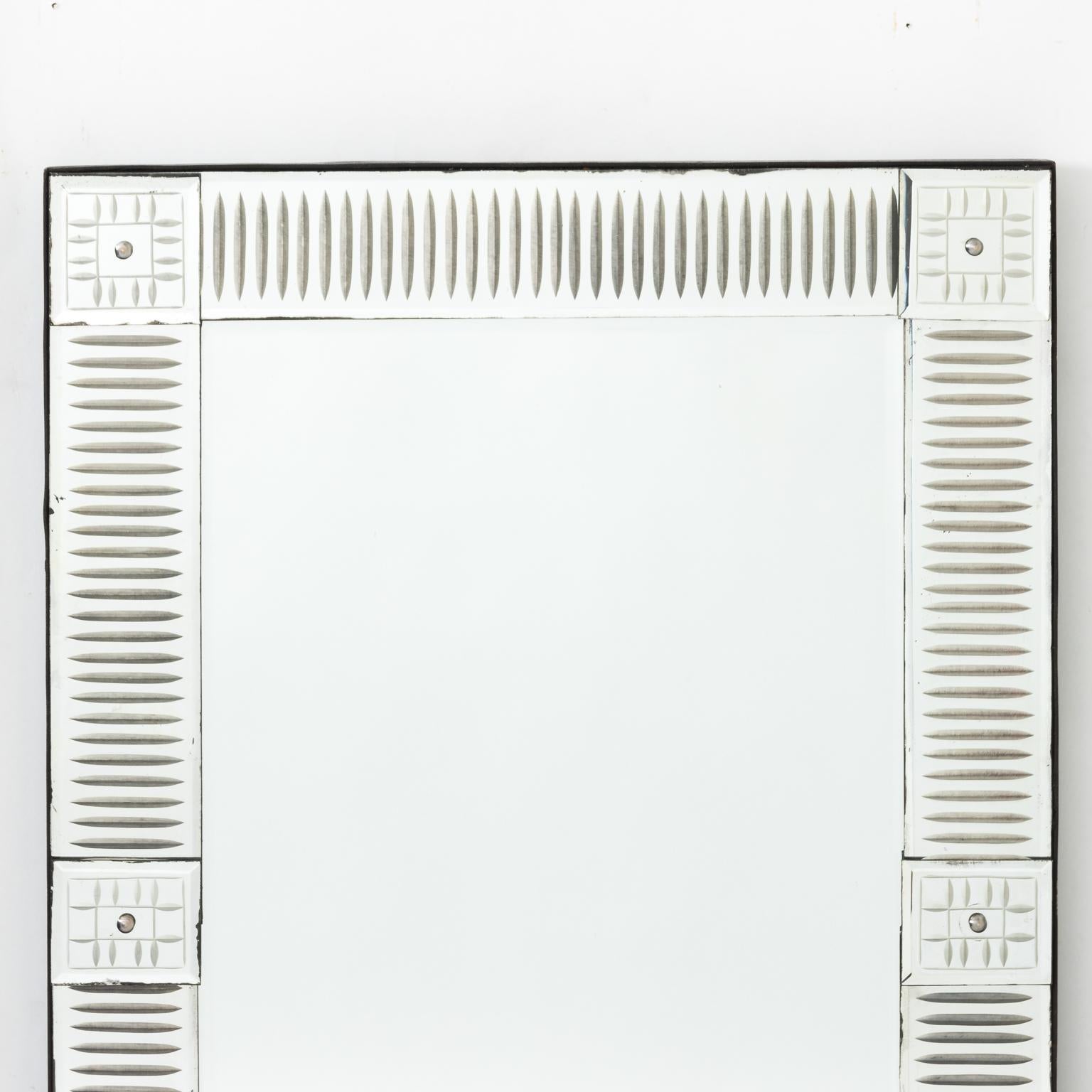 White painted Venetian style mirror in reeded glass frame with six geometric glass inserts.