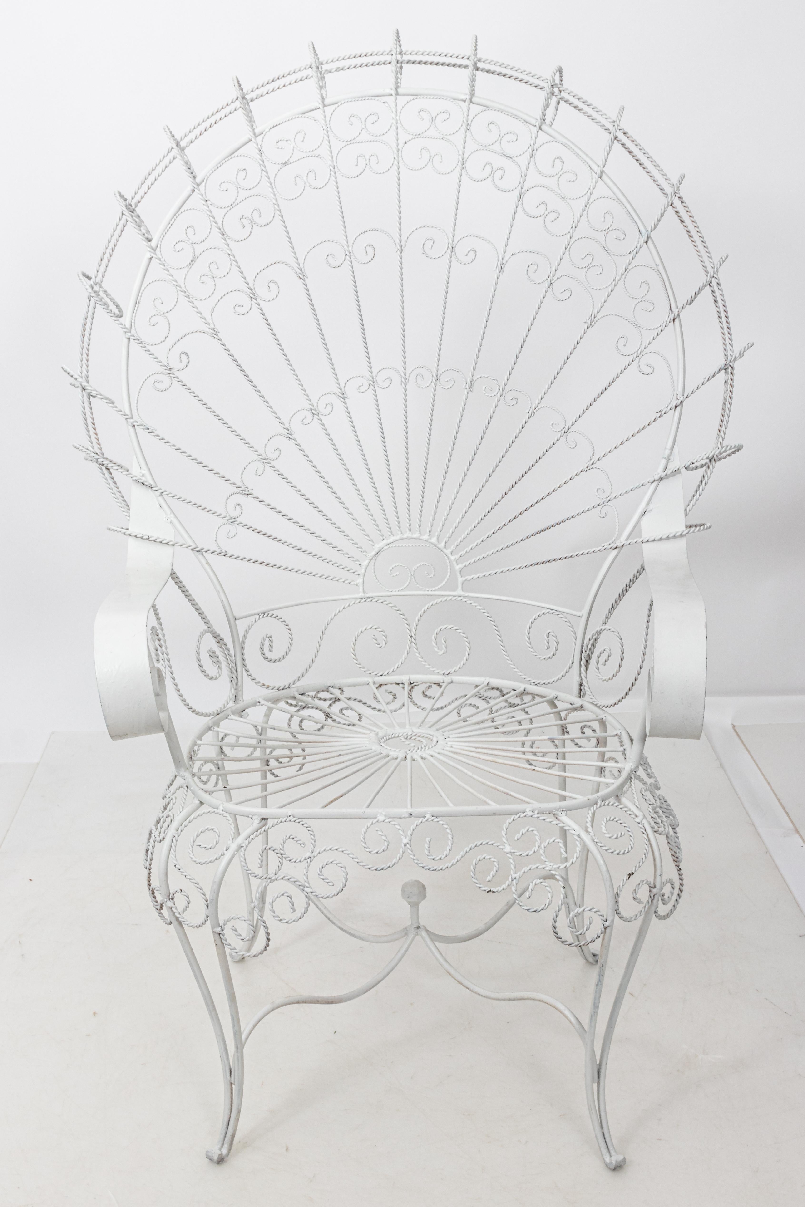 English Country metal wire peacock outdoor armchairs for the garden. These Victorian style chairs were produced later in the 20th century in England. High-quality twisted wirework frame features an ornate fanned back and scrolled wrought iron