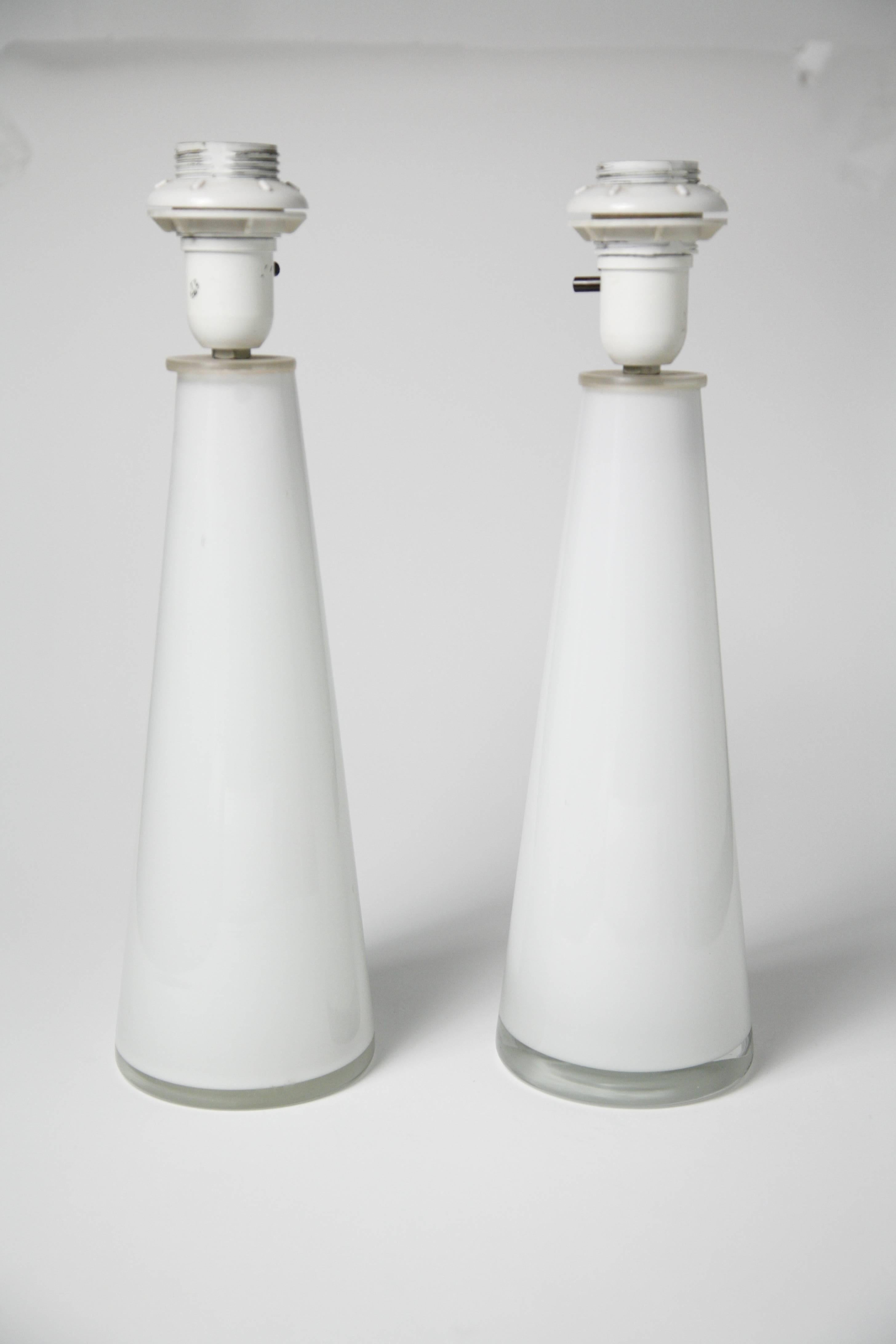 Pair of white heavy Orrefors glass lamps conical shaped, white glass incased in a layer of clear glass modern looking even after 50 years hand crafted incredible quality and design.