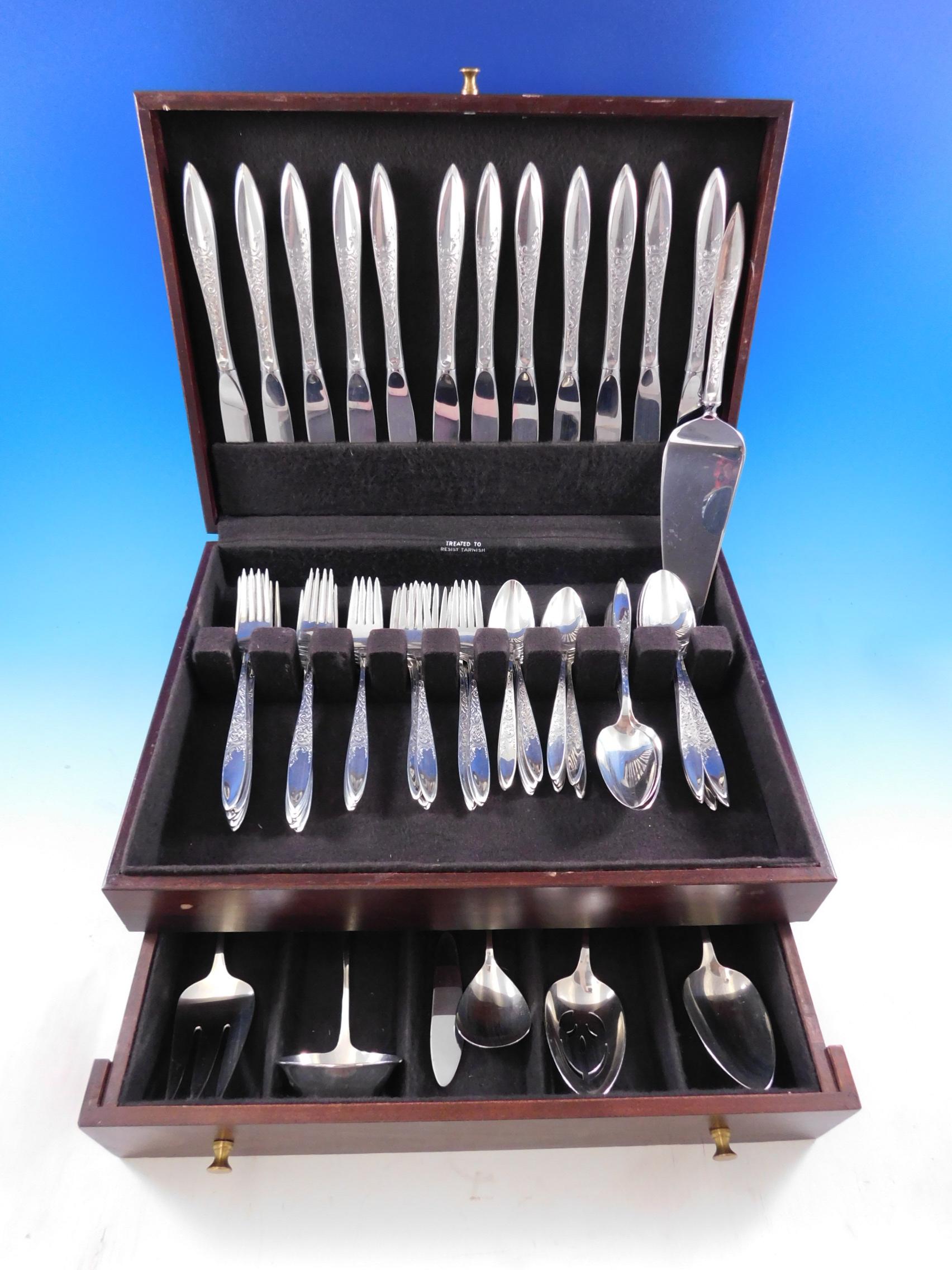White Paisley by Gorham sterling silver Flatware set - 67 pieces. This pattern was introduced in the year 1966 and features a contemporary shaped handle that is partially engraved with flowing scrolls and floral detailing. This set includes:

12