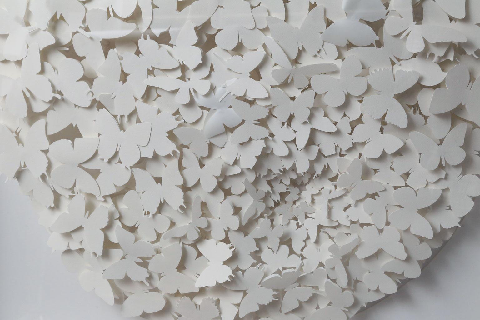 White paper butterfly box: the butterflies are handcut from Strathmore Aquarius II 80 lb paper. The use of white reduces the butterflies to their purest form and they are arranged to appear animated as if in flight. All papers, mats and backers are