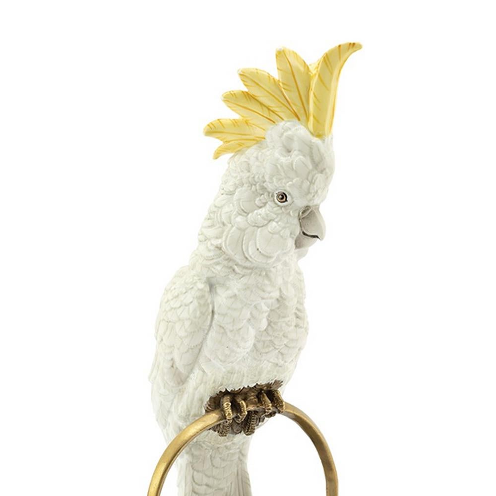 Sculpture white parrot on ring in hand painted
white porcelain with brass details.