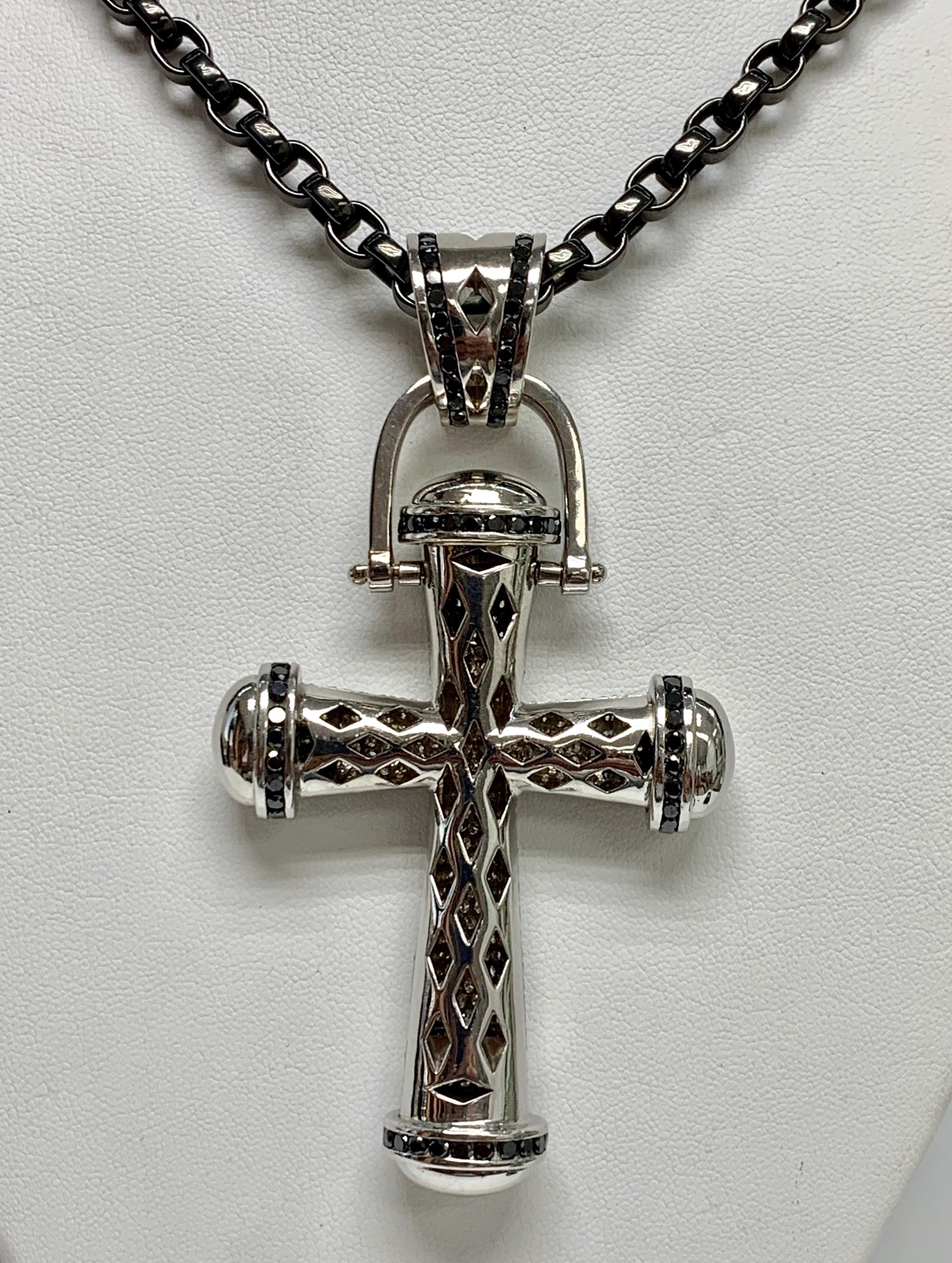 White Pavé Diamond, White Gold Cross Pendant. 

Featuring an exquisite Black Pavé & White Pavé Diamond. with a total weight of 22.00 carats; set in 14 White Gold; with a Stainless Steel Chain, Size 20