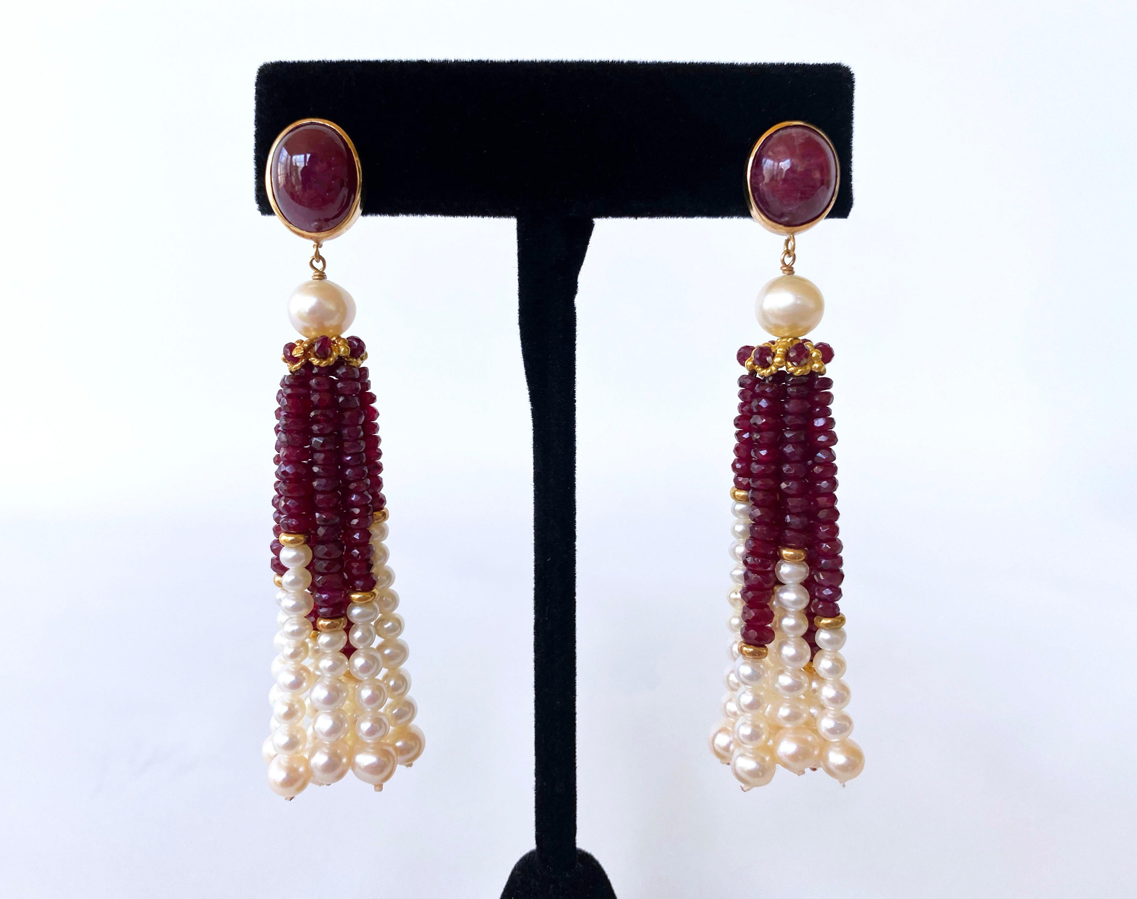 Gorgeous pair of Tassel Earrings by Marina J. This lovely pair features two large oval cabochon Ruby stones (9mm x 10mm), bezel set in 14k Yellow Gold. A beautiful round 7mm Pearl sits atop a 14k Yellow Gold cup decorated with Rubies, from which