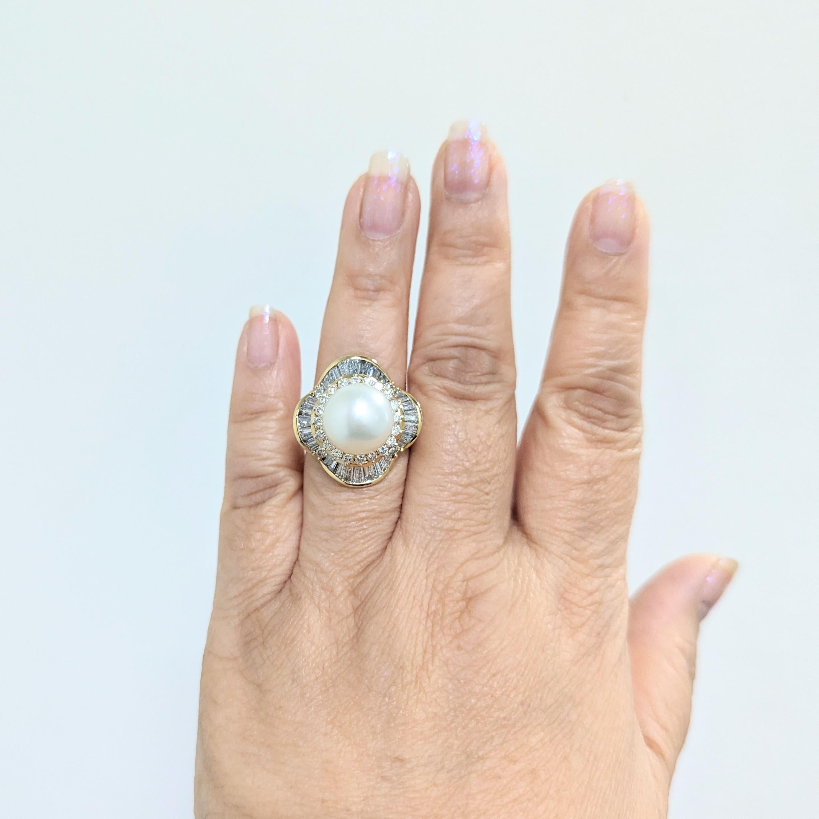 Beautiful large white pearl round with 2.70 ct. good quality white diamond rounds and baguettes.  Handmade in 18k yellow gold.  Ring size 9.25.