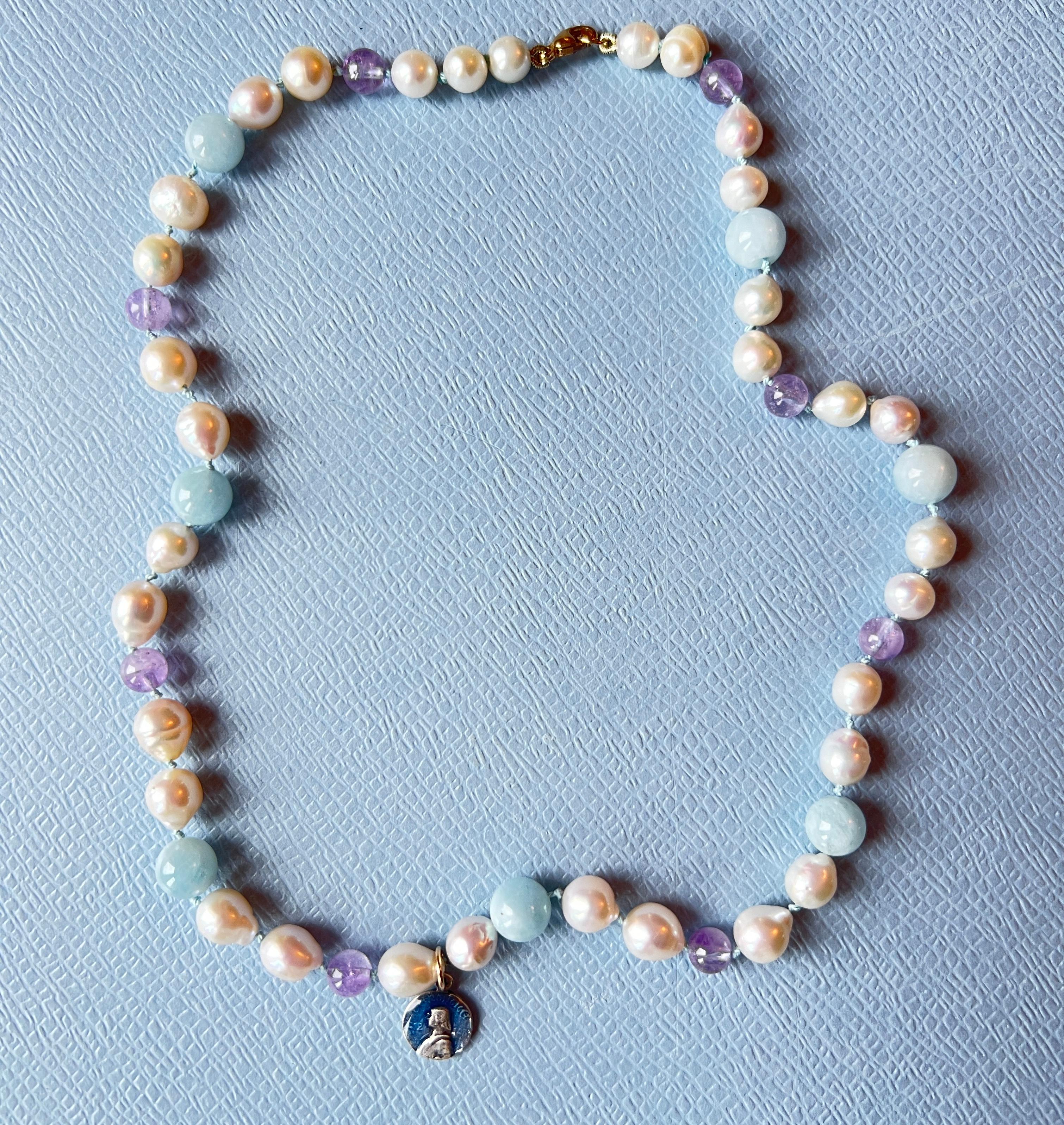 White Pearl Choker Necklace Aquamarine Amhetyst Joan of Arc
Gold Filled Clasp

Length 16 inches, 41 Cm

Designer: J DAUPHIN 

Amethyst is celebrated for its stunning violet hues and its profound spiritual significance. It is often referred to as a