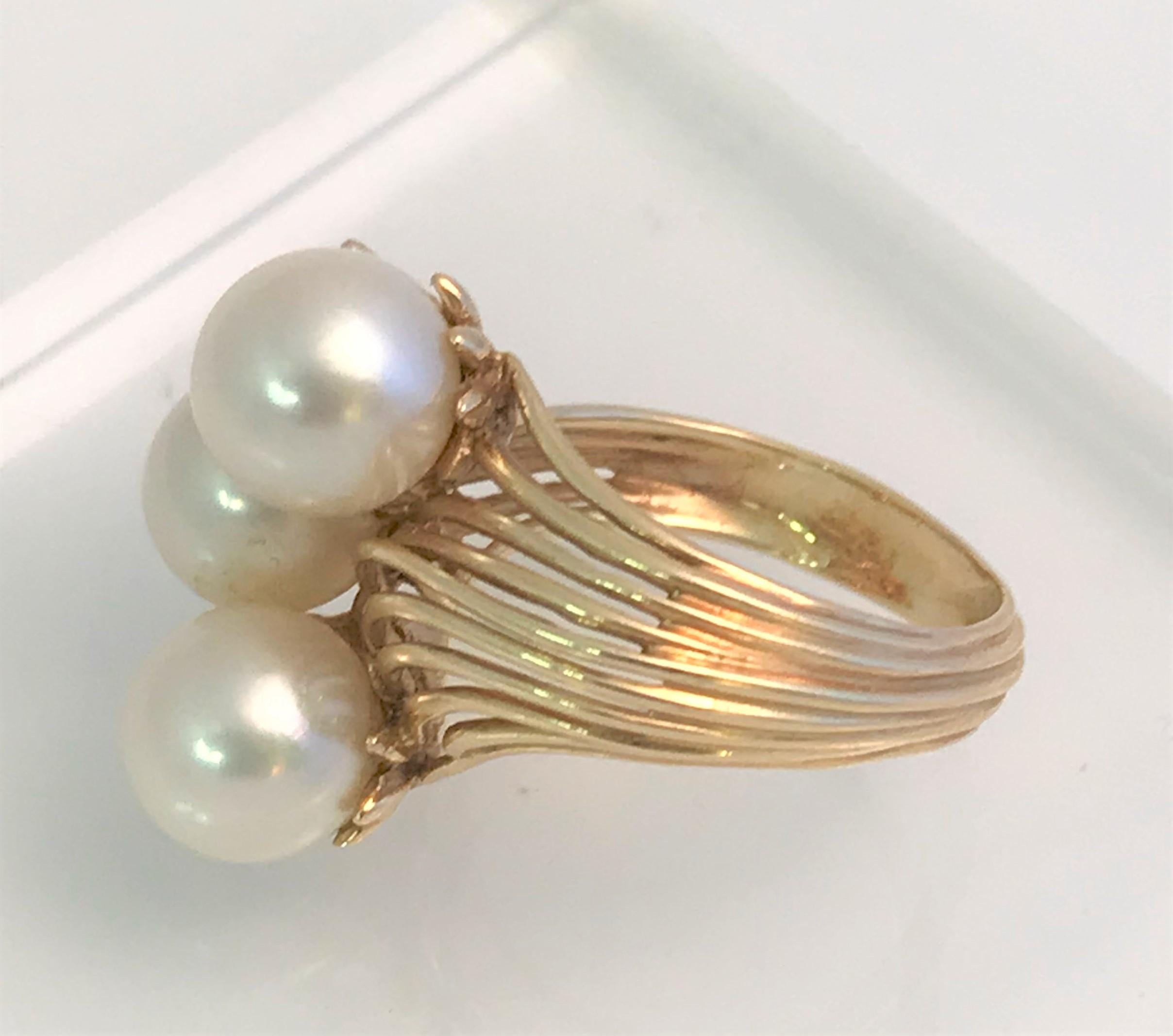 This beautiful ring is timeless and a must have!
14 karat yellow gold
3 white pearls, approximately 8mm round
4 round diamonds, approximately .05 each
Beautiful open wave shoulders and ribbed shank.
Size is approximately 5.5