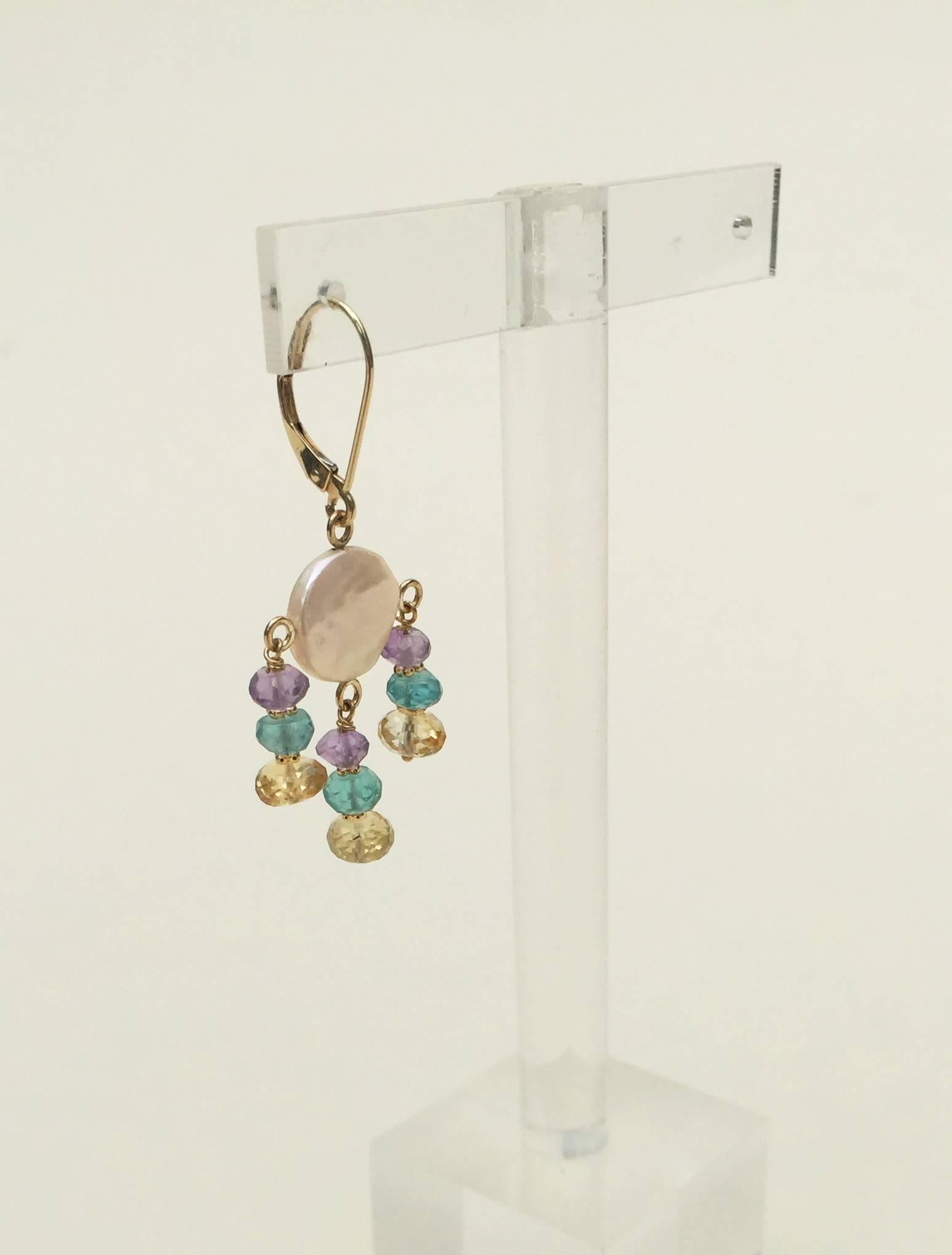 These delicate looking earrings (1.5 inches) are whimsical with a pastel color palette. The pale amethyst, topaz, and citrine highlight the glow of the white coin pearl. The earrings are accented with 14k yellow gold roundels and lever back hooks