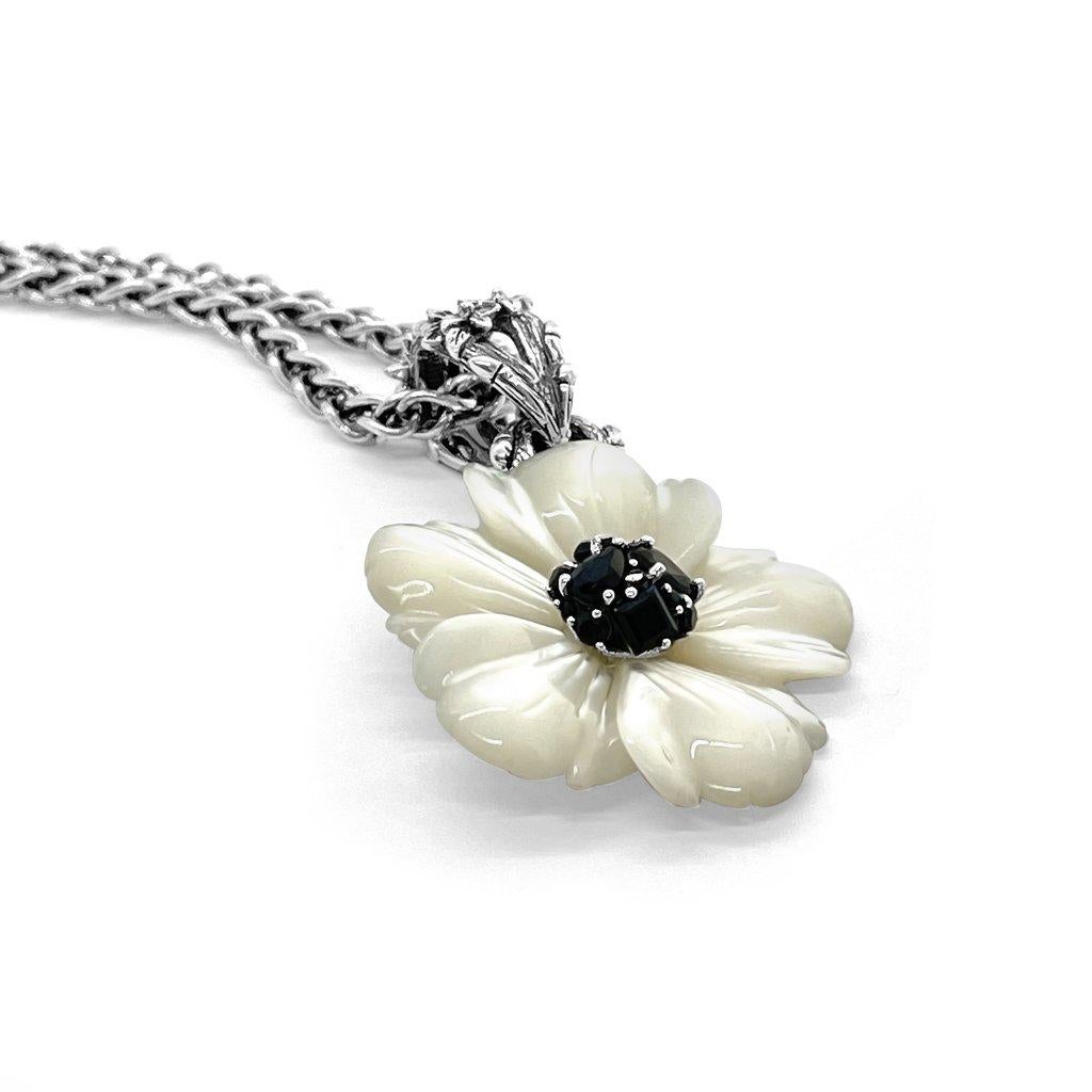 Step into a realm of eternal elegance with the White Mother of Pearl Flower Pendant, adorned with a captivating Black Spinel gemstone center and complemented by a delicate engraved sterling silver toggle. This enchanting piece embodies the timeless