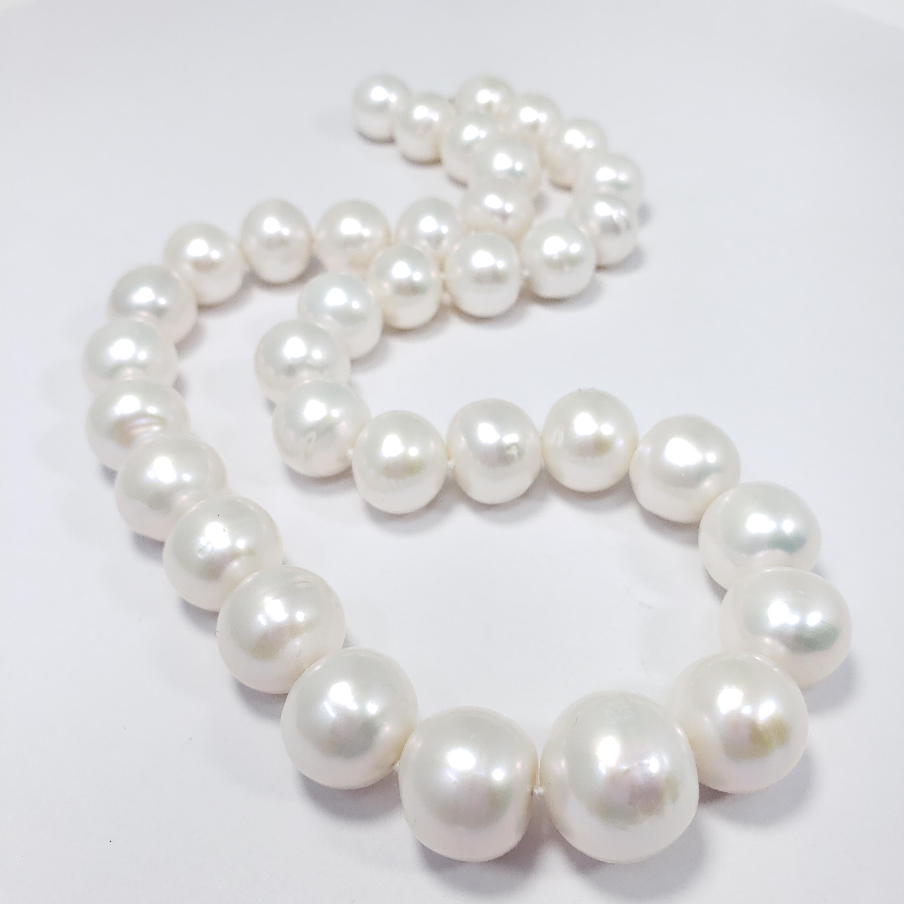 An exquisite South Sea pearl necklace! Features graduated white pearls on a knotted string, accented with a 14K yellow gold crabclaw clasp. A perfect final touch to any style!

Hallmarks: 585
Pearls range from 11.5mm to 14.9mm
Necklace length 46cm