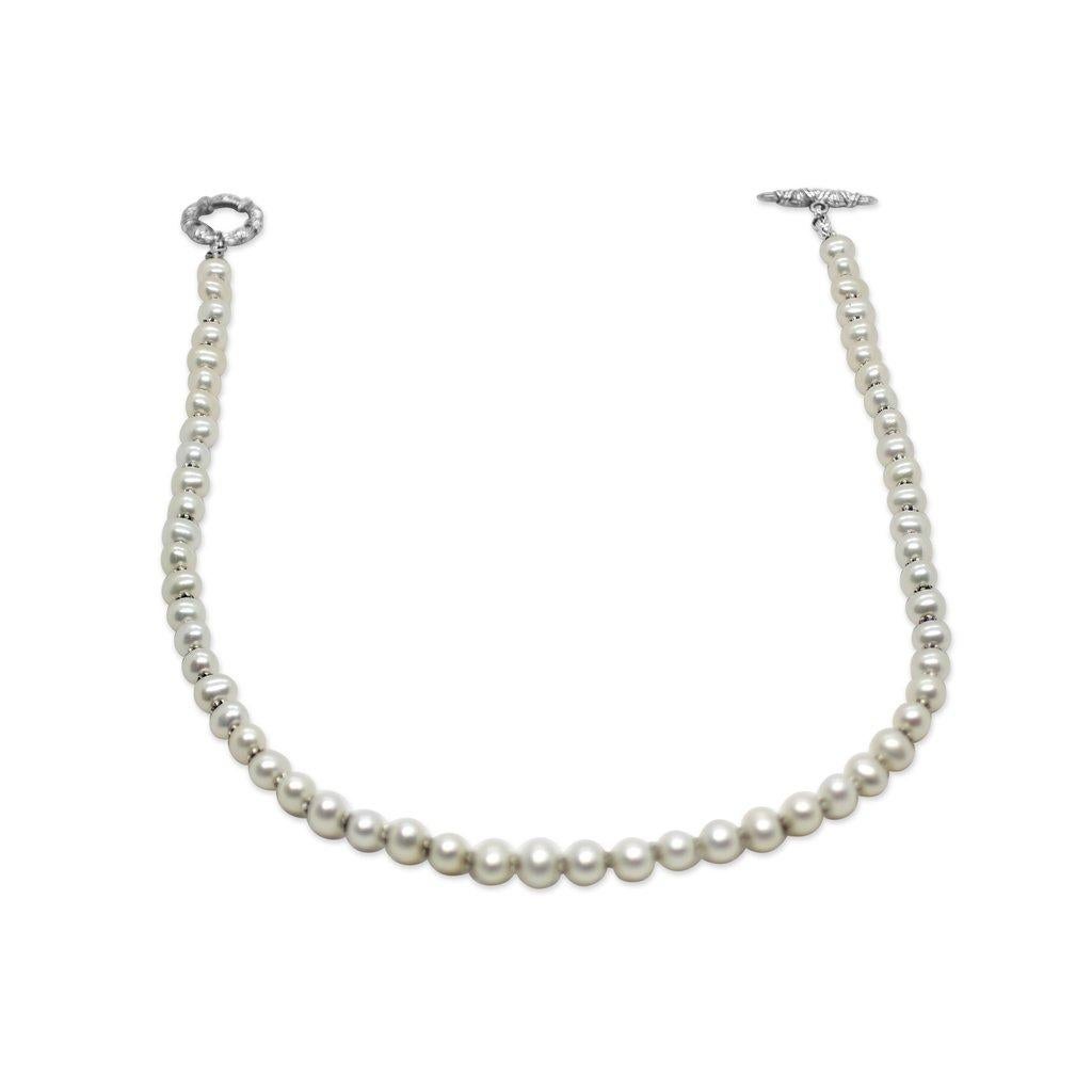 Indulge in the timeless sophistication of the White Pearl Necklace in Sterling Silver by Stephen Dweck. Crafted with precision and artistry, this exquisite necklace features luminous white pearls delicately strung together on a sterling silver