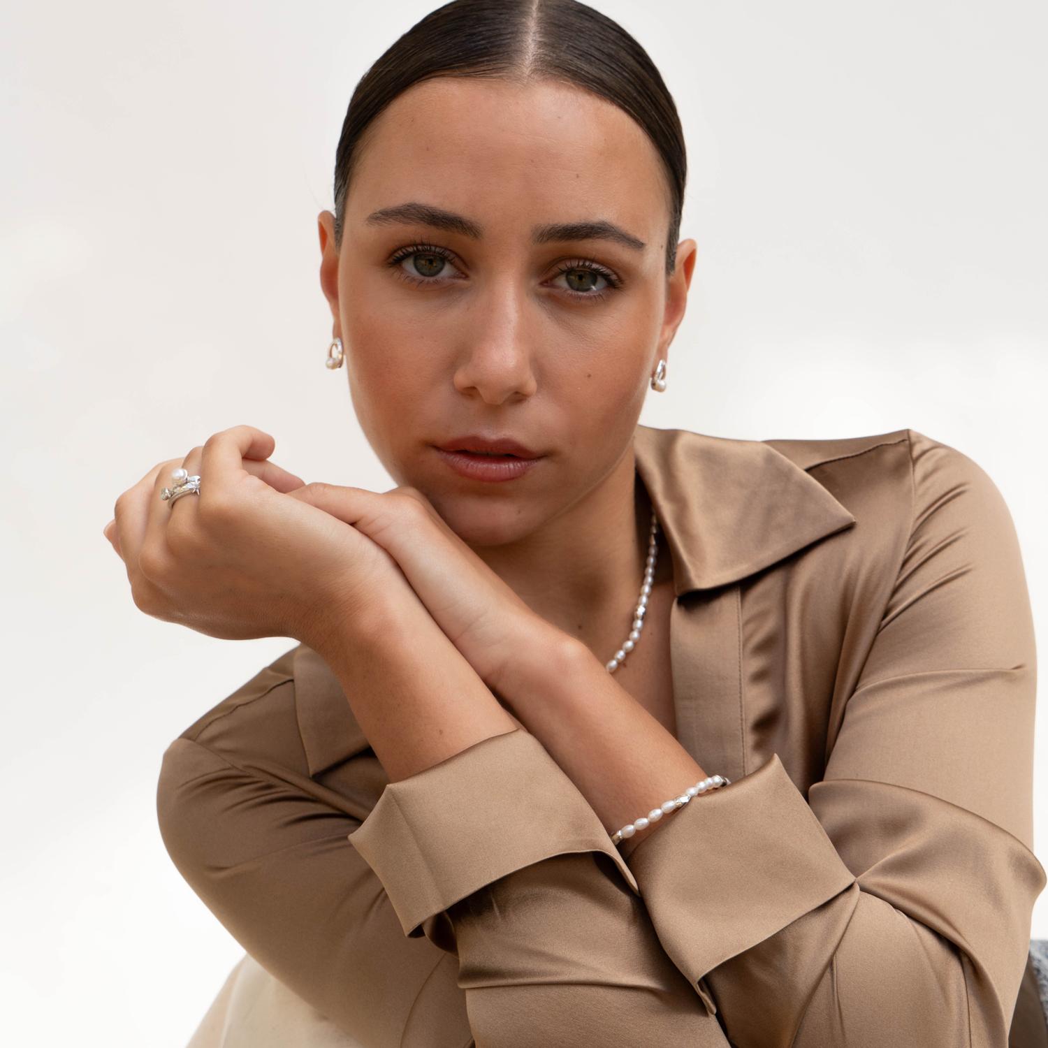 Thread by hand in our London studio, this lustrous pearl bracelet will slip seamlessly into your collection of style staples. The modern mix of oval white freshwater pearls and 5 shiny sterling silver ocean pebble beads makes it perfect for layering