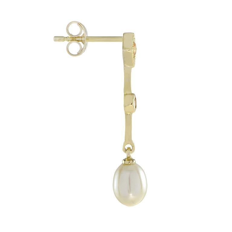 These citrine and pearl earrings feature 3.3 carats drop shape pearl set on bars with four citrine in bezel and prong set with millgrain on studs. 14K Yellow Gold. 
Information
Width: 5 mm.
Length: 27 mm.
Weight: 1.40 g. (approx. in total)
Backing: