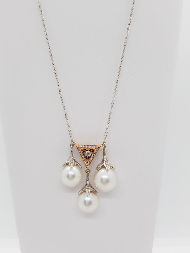 Gold tone bow and pink white pearl necklace 