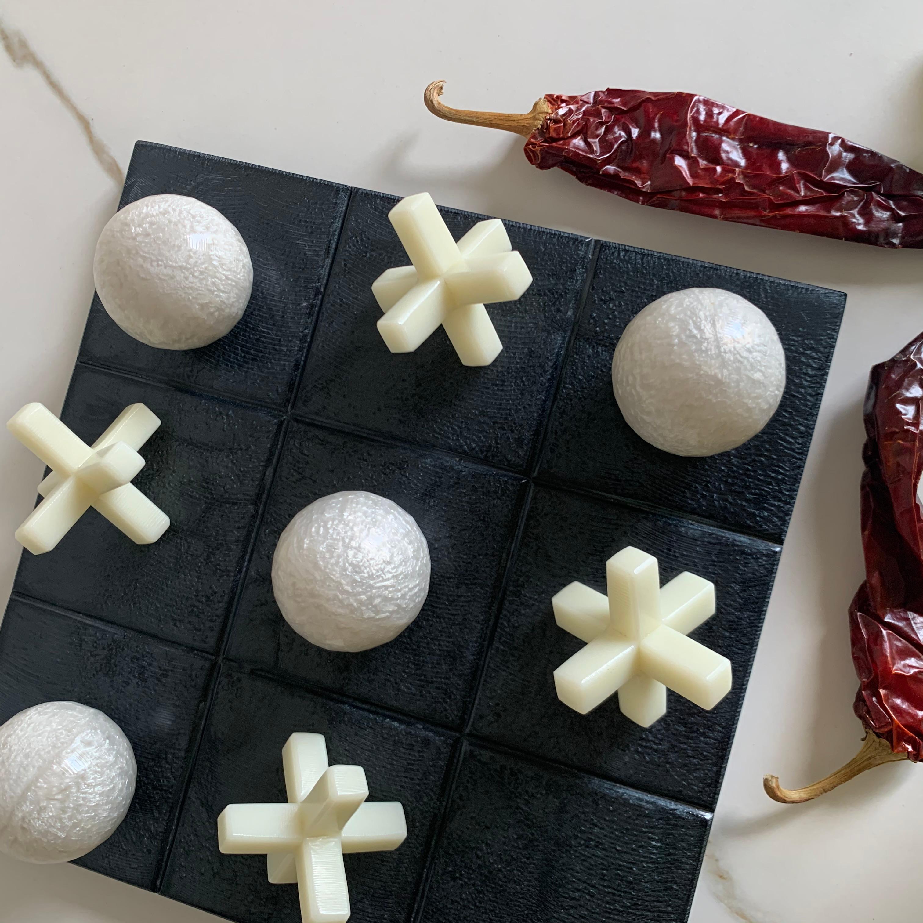 Our Tic Tac Toe is a beautiful, modern and fun take on the classic game. The three dimensional pieces are handmade in white pearl resin, and board is in black pearl resin. It will be the coolest statement piece on any coffee table.

Materials:
