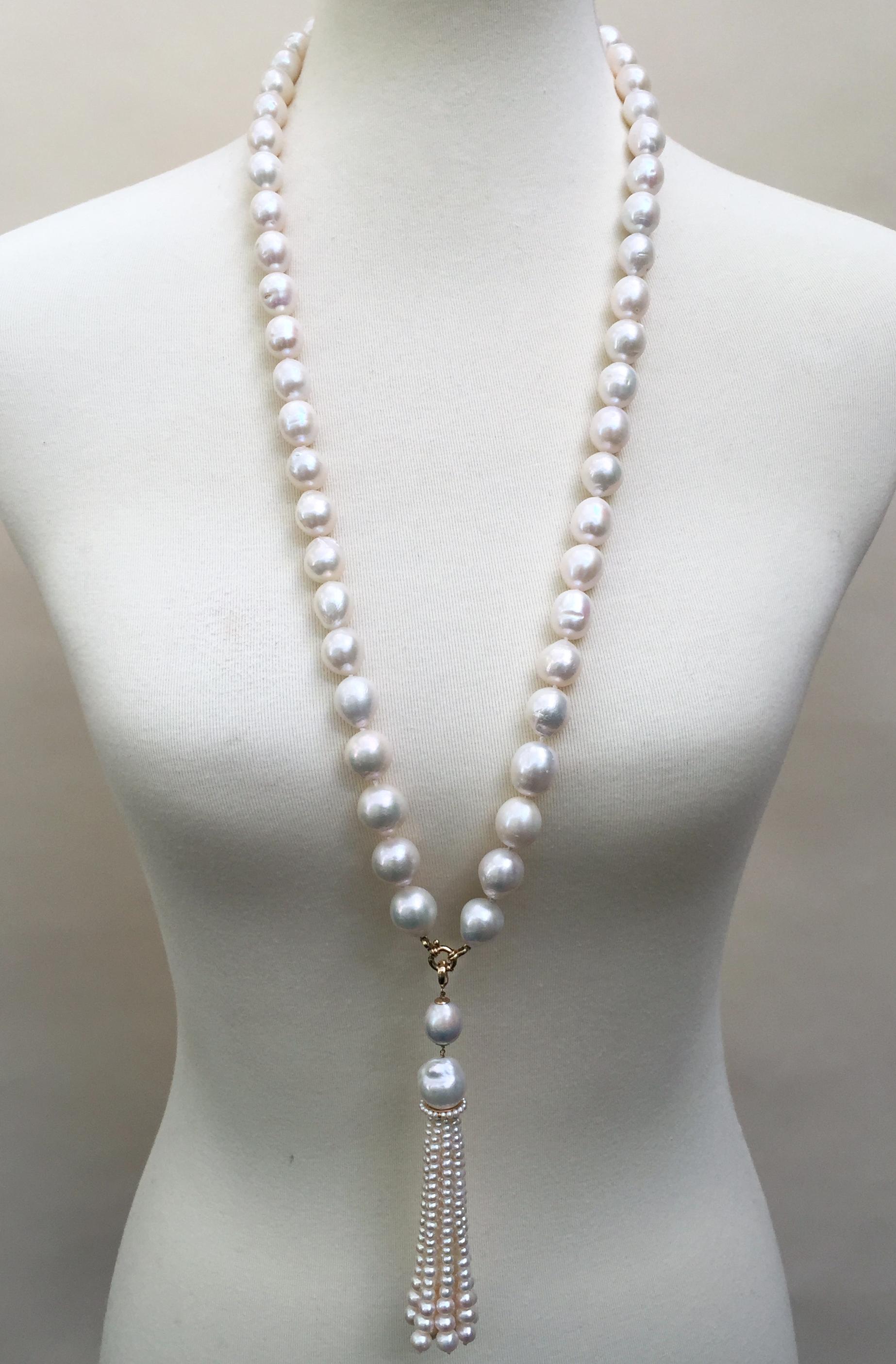 The glowing white pearl sautoir necklace has a gorgeous graduated white pearl tassel and a 14k yellow gold clasp. Each pearl was careful chosen by Marina J., the oval shaped pearls of the necklace measure 13-17mm.  At 33 inches long the necklace has
