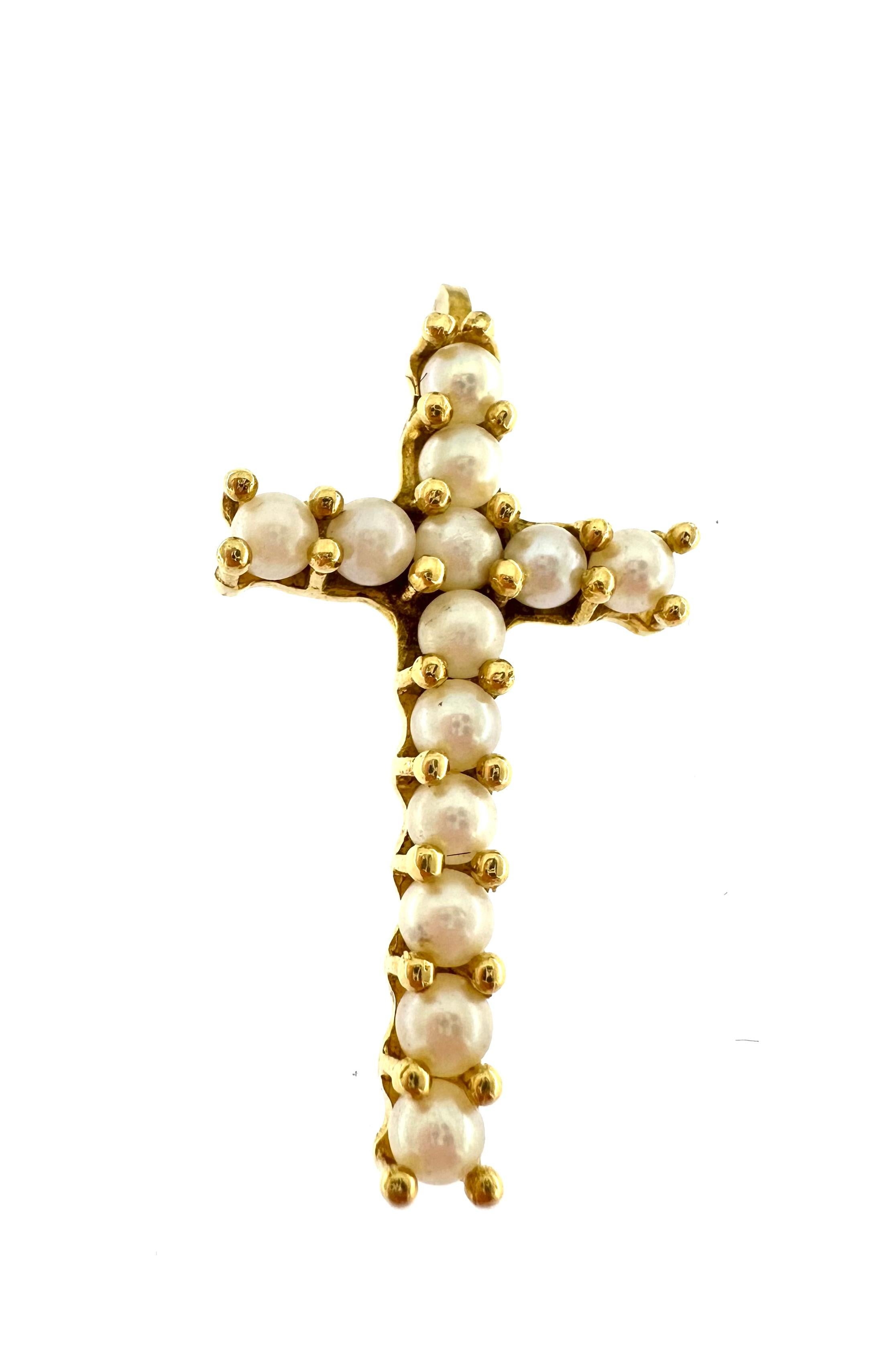 Beautiful, elegant and simple, this cross is decorated with 13 embedded round white pearls. The pendant is in 18kt yellow gold, the condition is excellent almost like new, it has been worn very little.