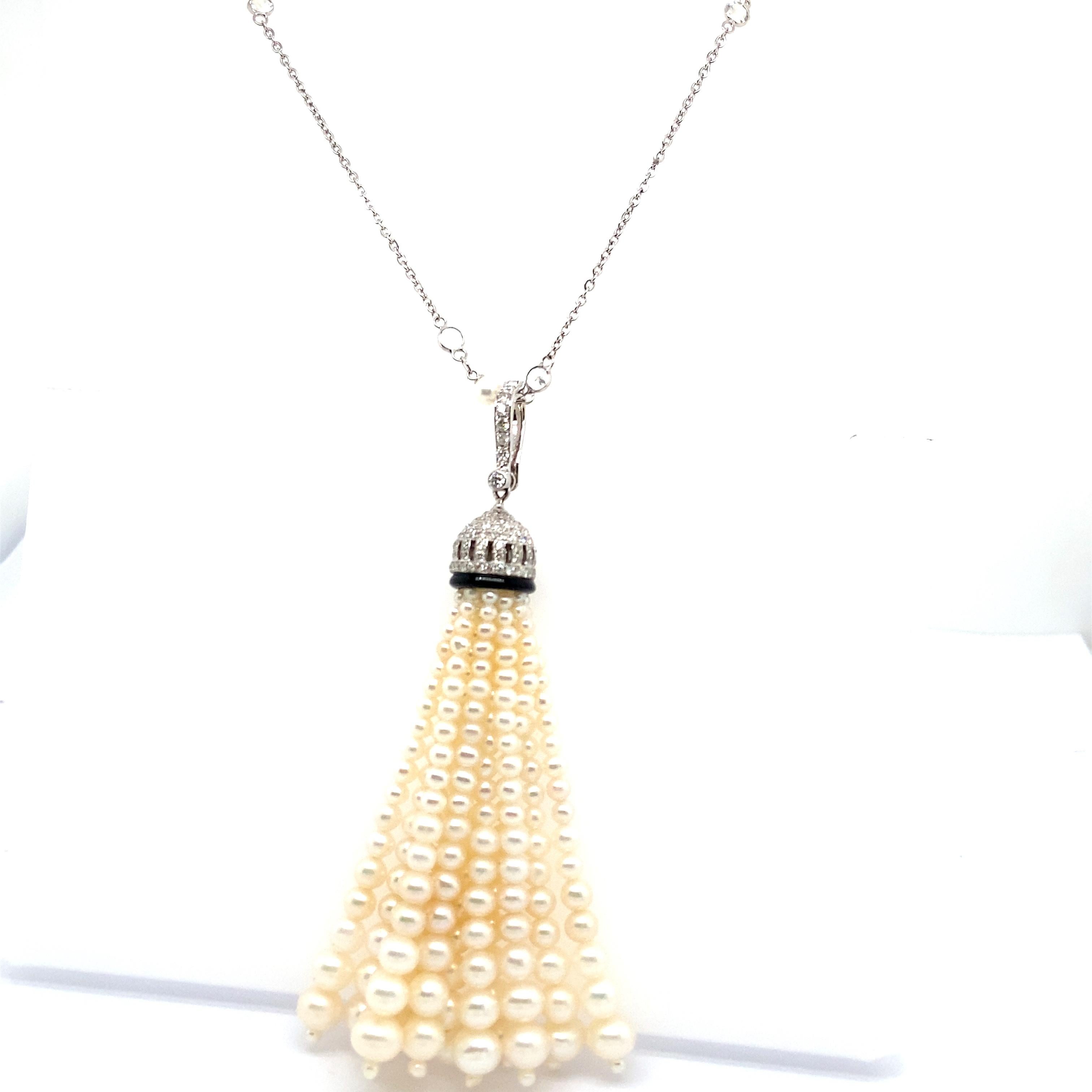 White Pearls, Black Onyx, and White Diamond Gold Tassel Necklace:

An elegant tassel necklace, it features a black onyx situated underneath the diamond cup, along with white pearls weighing 12.17 carat, and white diamonds weighing 0.67 carat. The