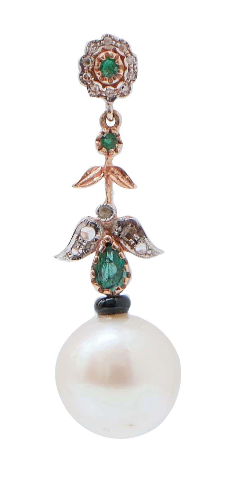 Amazing earrings in 9 kt rose gold and silver structure mounted with a flower of diamonds and an emerald in the upper part; in the middle, emeralds  and leaves studded with diamonds. Below, a pearl with an onyx.
These earrings were totally handmade