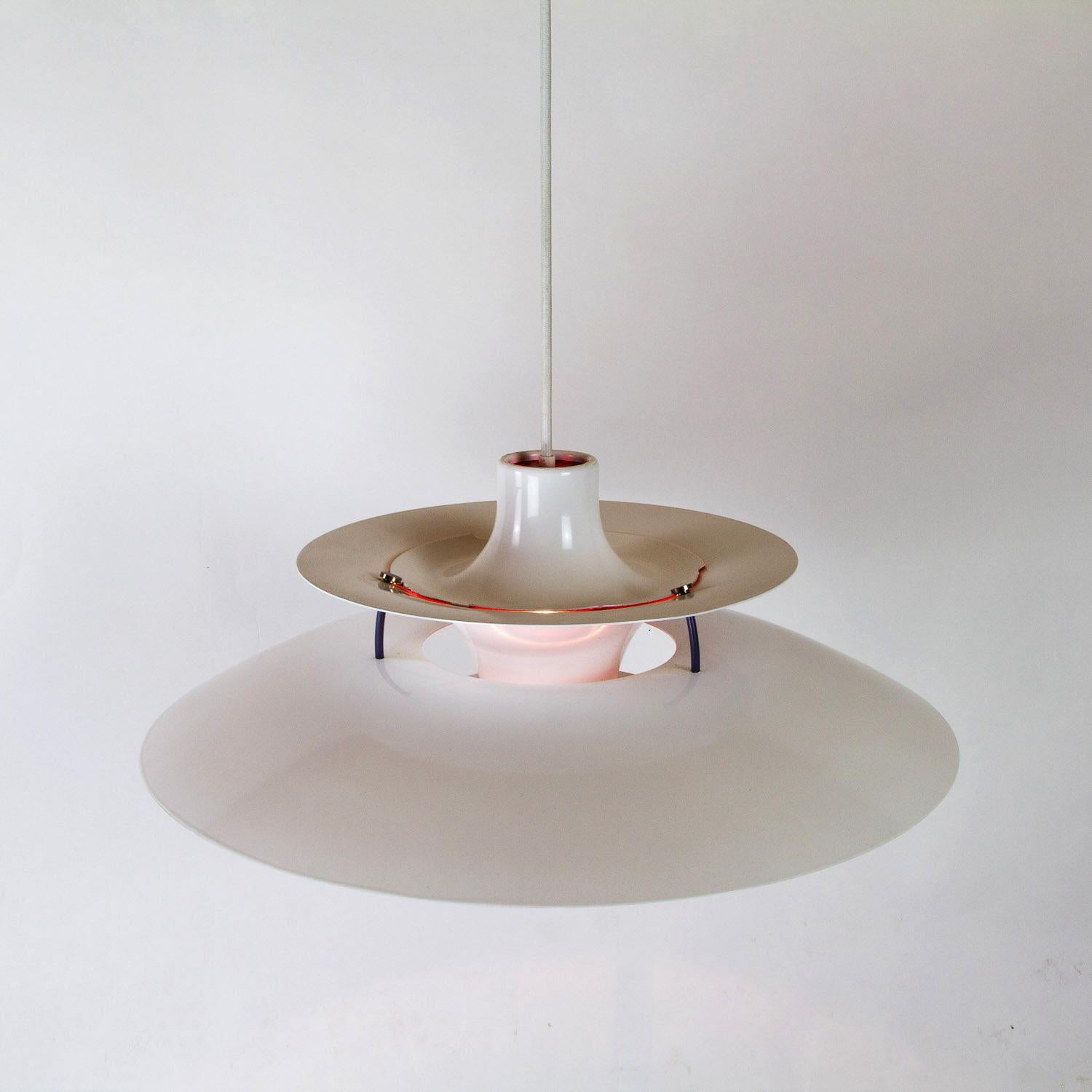 A restored and resprayed white PH5 ceiling light designed by Poul Henningsen for Louis Poulsen. Designed in 1958 the PH5 is one of the most elegant and iconic pendant lights to come out of Denmark. The layered shades have been designed to hide the